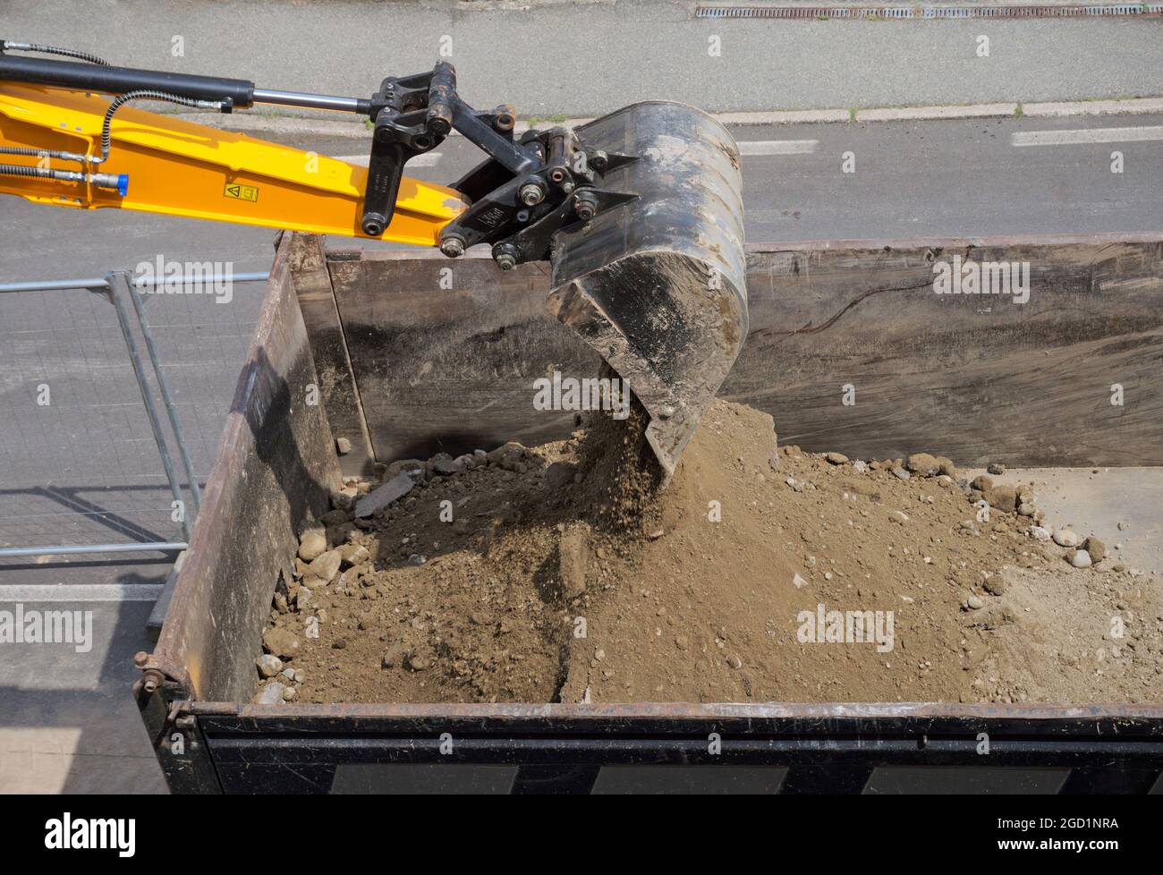 Bagger, der Schmutz in einen Muldenkipper einlädt Stockfoto