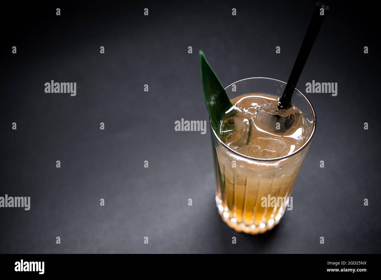 Erfrischendes Limonadengetränk oder Cocktail mit Eiswürfel in Glas auf schwarzem Hintergrund Stockfoto