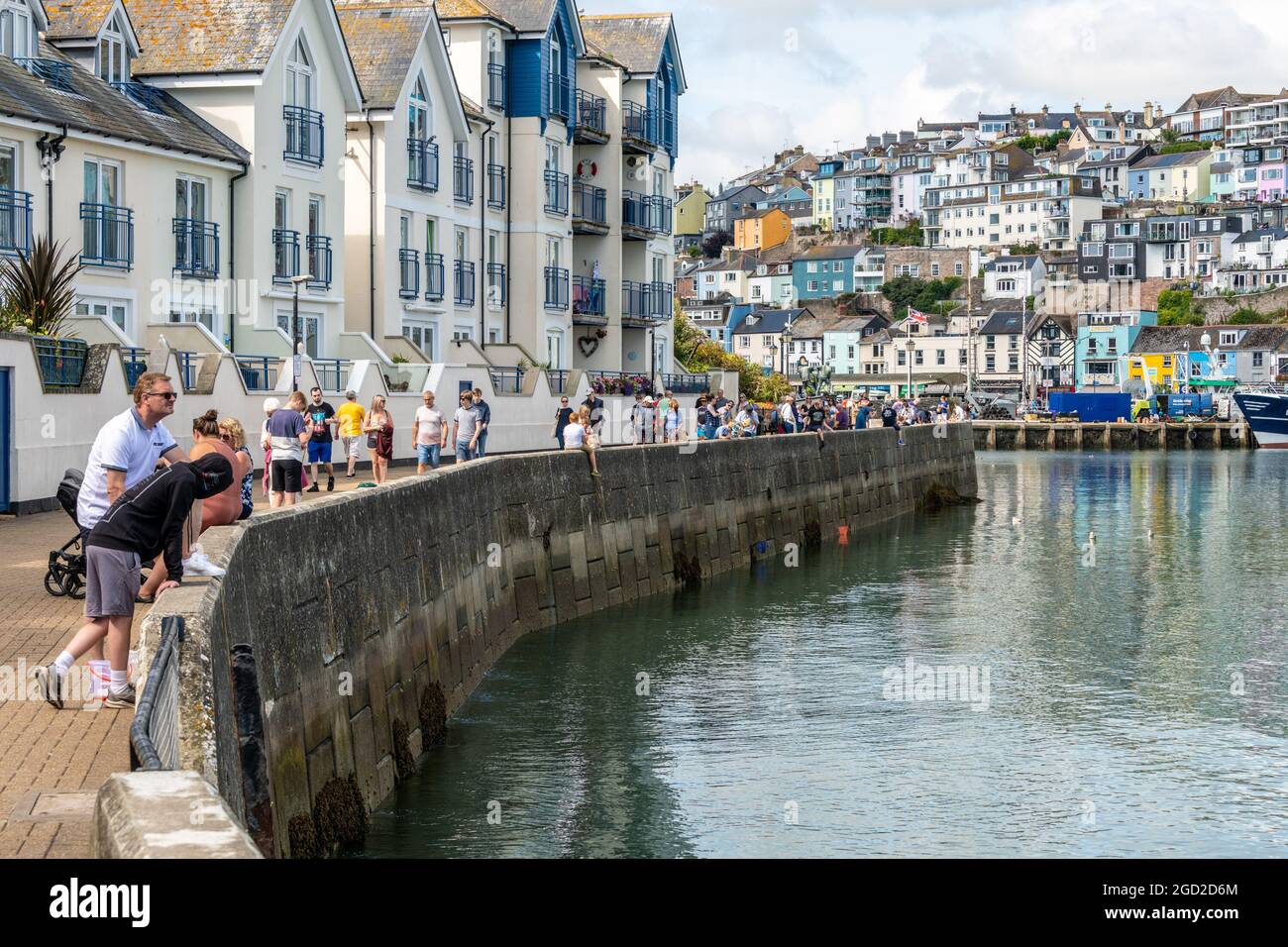 Brixham, Großbritannien. Dienstag, 10. August 2021. Gutes Wetter erfüllt die Stadt Brixham mit Touristen, die sich um den Kai umsehen. Stockfoto