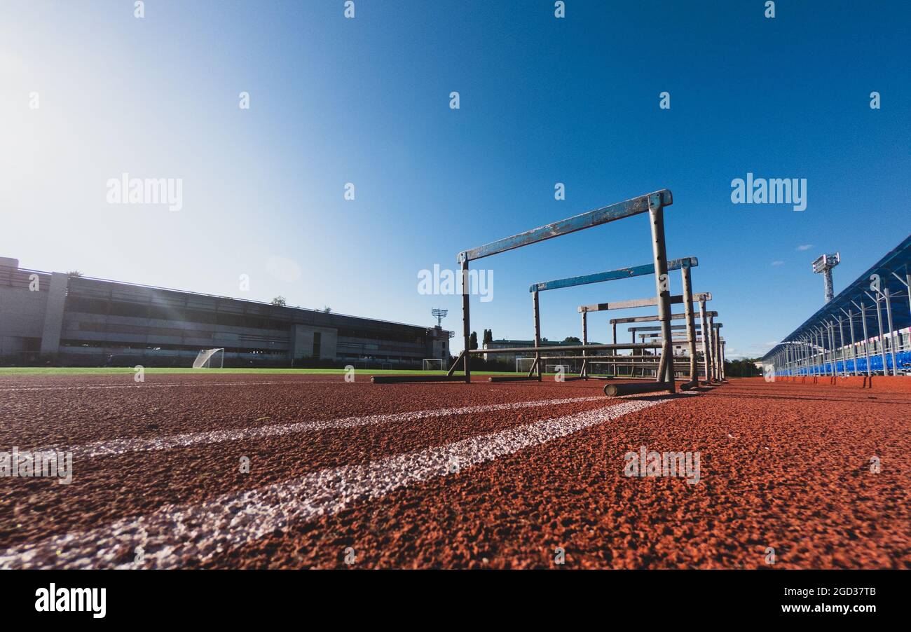 Hürde für das Rennen auf der Stadionstrecke an sonnigen Tagen. Blauer Himmel. Stockfoto
