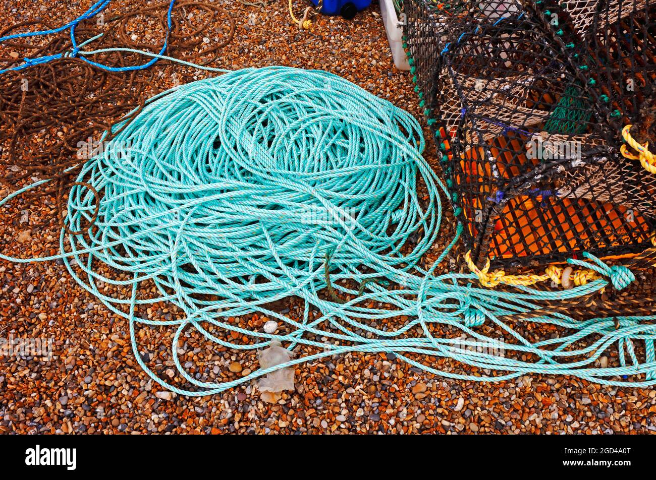 Eine Nahaufnahme von Seilen und anderen Geräten, die am Strand über dem hohen Wasserstand gelagert werden, um kommerzielle Fischerei in Cley-next-the-Sea, Norfolk, England, Großbritannien, zu betreiben. Stockfoto