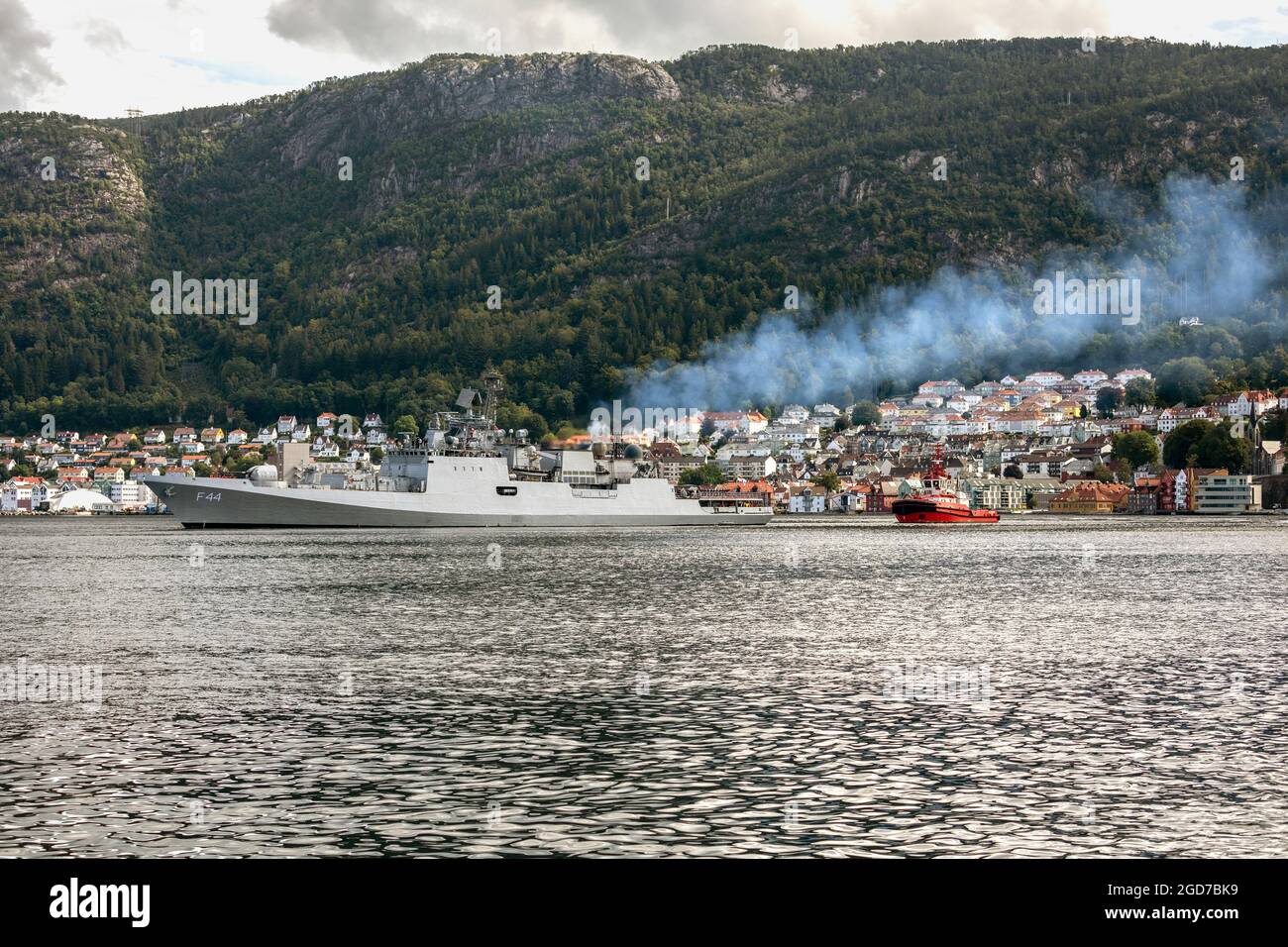 Indische Fregatte IN Tabar F44 bei Byfjorden, Abfahrt vom alten Hafen Bergen, Norwegen. Unterstützt durch den lokalen Schlepper BB Coaster Stockfoto