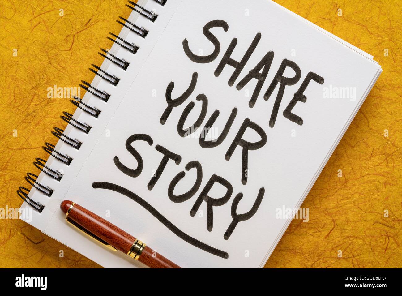 Teilen Sie Ihre Geschichte – motivierende Handschrift in einem Spiralnotizbuch, Erfahrungsaustausch und Weisheitskonzept Stockfoto
