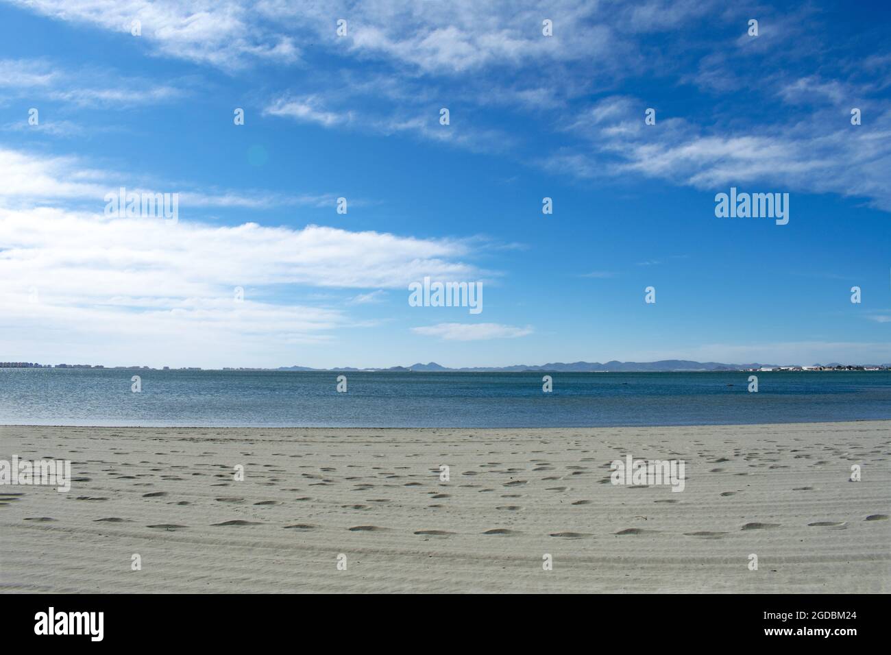 Feiner Sandstrand bei Lo Pagan am Mar Menor, Murcia, Spanien. Frühlingstag mit klarem, blauem Himmel und unberührten Sandstränden, am ruhigen, blauen Wasser. Stockfoto