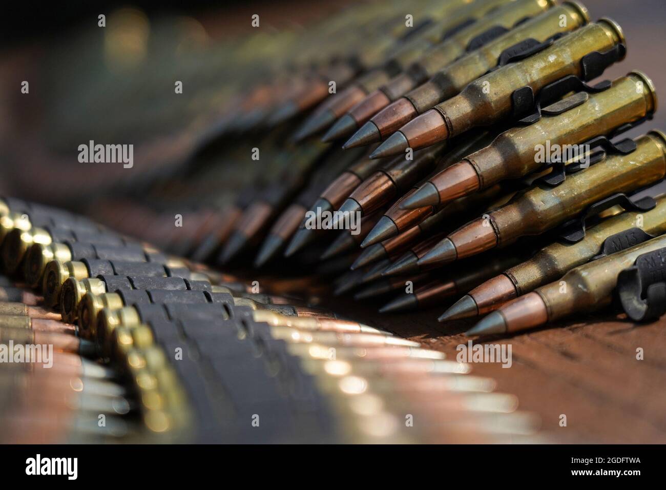 Verbundene Gürtel mit 7,62 mm-Patronen sind auf einem Tisch zu sehen, als Fallschirmjäger, die dem 6. Brigade-Ingenieur-Bataillon (Airborne), dem 4. Infanterie-Brigade-Kampfteam (Airborne), der 25. Infanterie-Division, der US-Armee Alaska, zugewiesen sind, M240B-Maschinengewehre feuern, während sie Live-Feuertraining auf der Statler Range auf der Joint Base Elmendorf-Richardson, Alaska, 3 2021. Die Soldaten übten die Identifizierung und das Einbinden von Zielen in unterschiedlichen Entfernungen, um ihre Fähigkeiten mit den Waffen in einer Unterstützung durch Feuerrolle zu festigen. (USA Luftwaffe Foto/Justin Connaher) Stockfoto