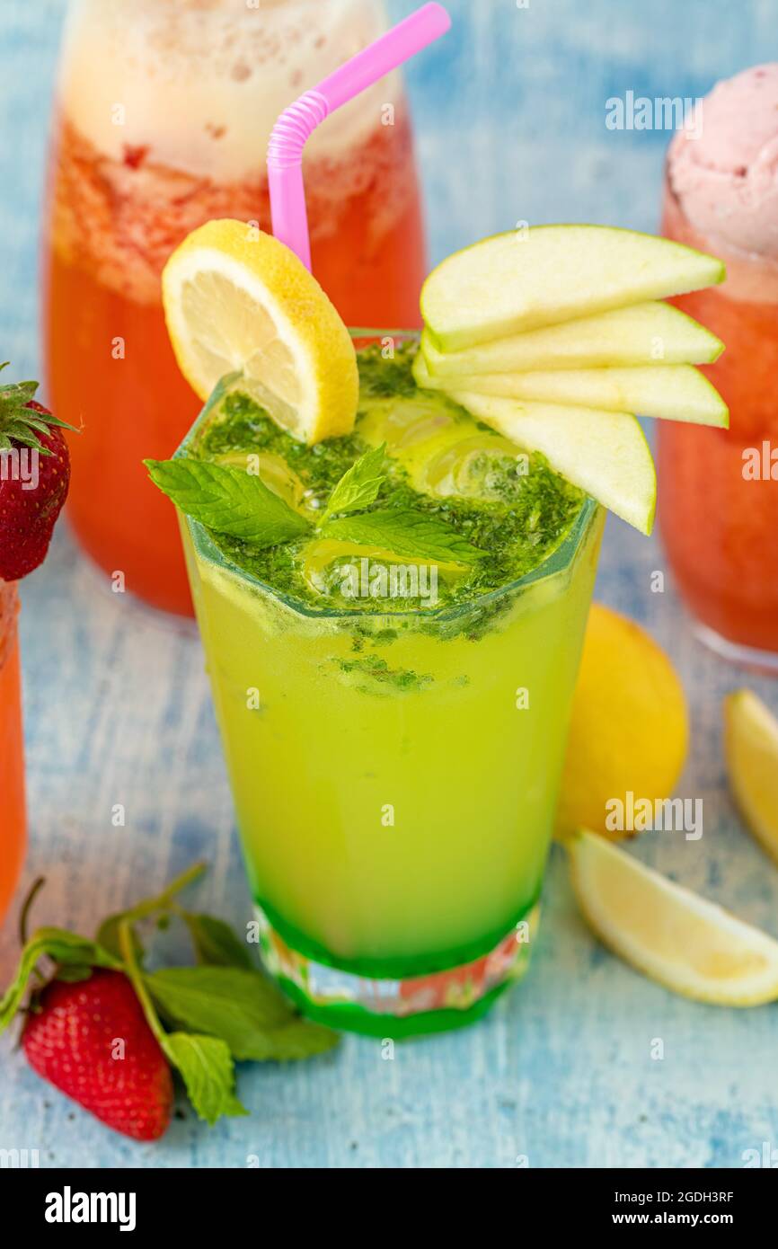 Erfrischende Limonade mit Zitrone, Erdbeere und Minze auf blauem Hintergrund Stockfoto