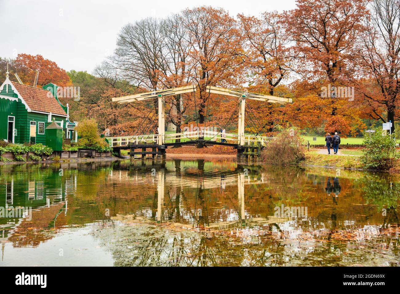 Niederlande, Arnhem, Holland Open Air Museum. Museumspark mit historischen Gebäuden. Herbstfarben. Häuser und Zugbrücke aus der Region Zaan. Stockfoto