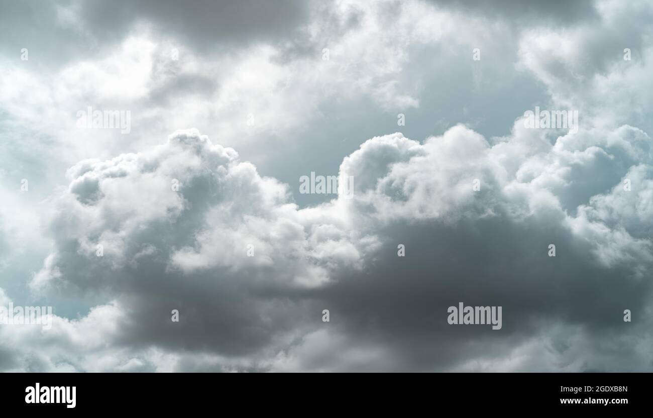 Bewölktes Himmel. Dunkler dramatischer grauer Himmel und weiße Wolken vor Regen. Wolkiger und launischer Himmel. Sturmhimmel. Wolkenlandschaft. Düsterer und launischer Hintergrund. Bedeckt Stockfoto