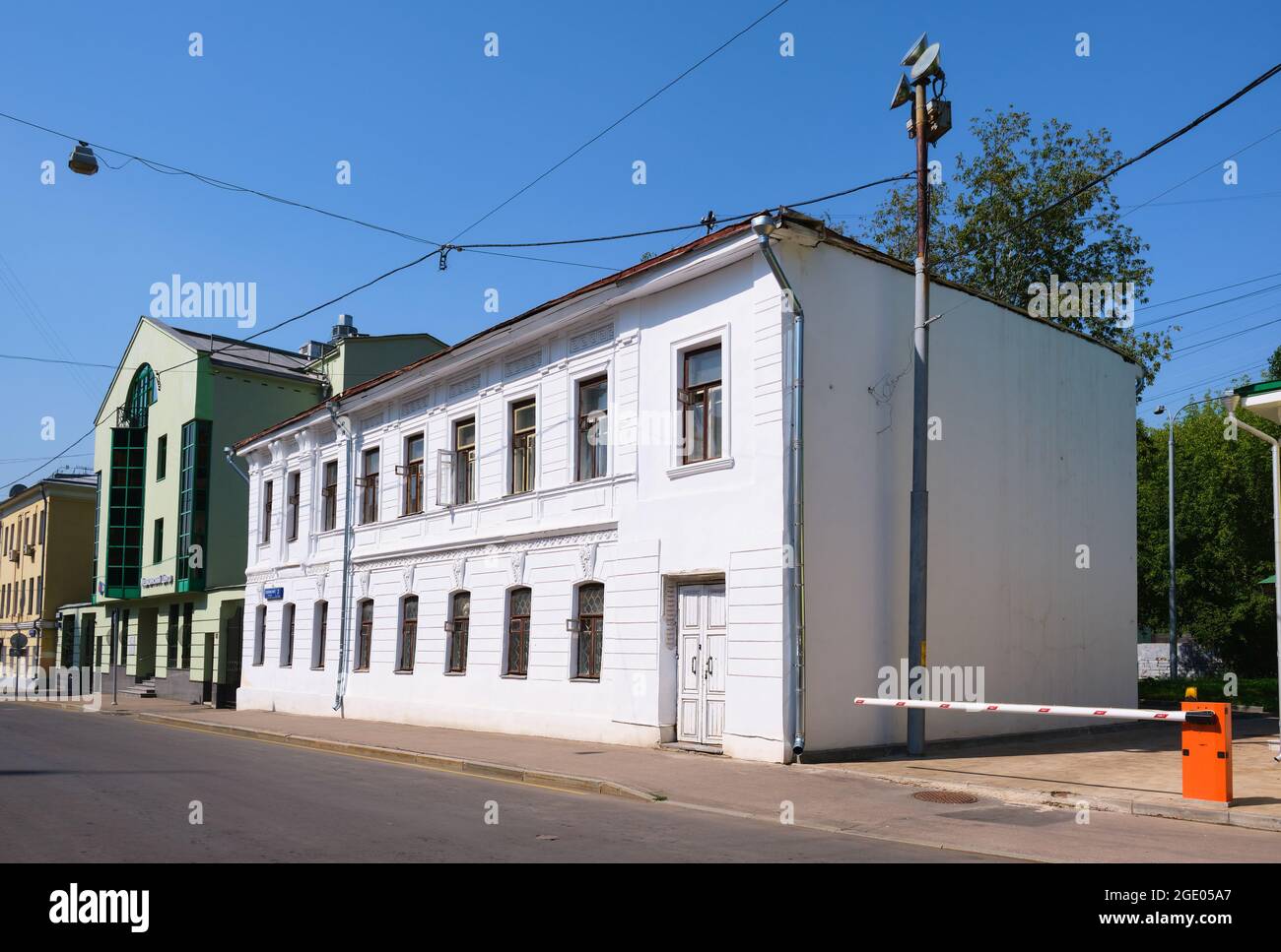 Weißes zweistöckiges Holzhaus mit steinernen Seitenwänden, verziert mit Stuck, Baujahr 1876, Architekturdenkmal: Moskau, Russland - 09. August 2021 Stockfoto