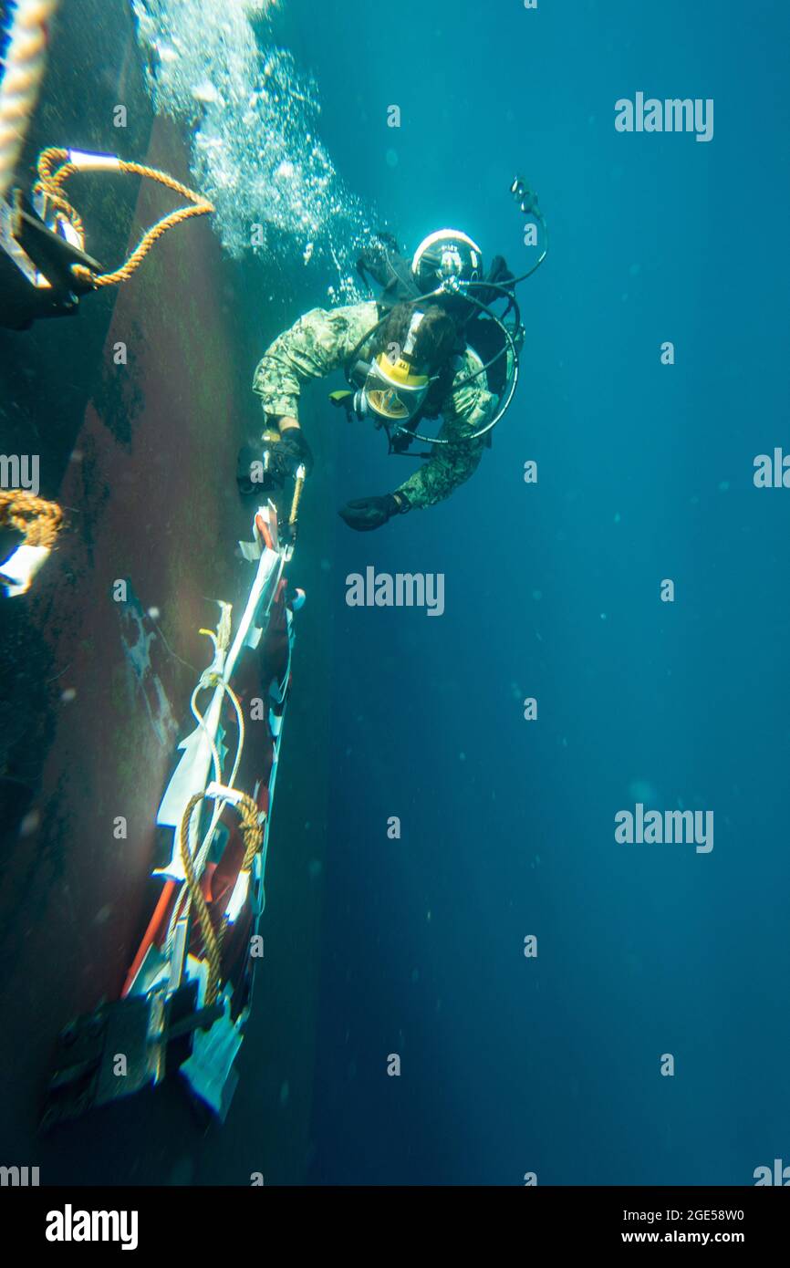 Brandon Barreto, der Marine Diver der 2. Klasse, der der Mobile Diving Salvage Unit (MDSU) 2 zugewiesen wurde, führt während eines großen Trainings (LSE 2021) Unterwasser-Kampfschadenreparaturen (BDR) auf dem Zerstörer USS Gonzales (DDG-66) der Arleigh Burke-Klasse durch. LSE 2021 demonstriert die Fähigkeit der Marine, weltweit präzise, tödliche und überwältigende Gewalt über drei Seestreitkommandos, fünf nummerierte Flotten und 17 Zeitzonen hinweg einzusetzen. LSE 2021 vereint Live- und synthetische Trainingsfunktionen, um eine intensive, robuste Trainingsumgebung zu schaffen. Es wird High-Fidelity-Schulungen und den realen Betrieb mit bui verbinden Stockfoto