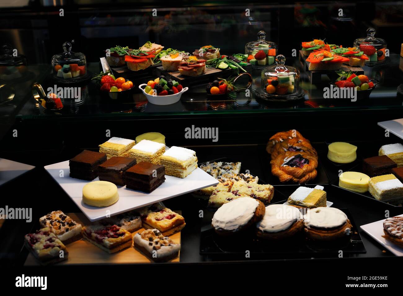 Schaufenster des Cafe-Shops mit verschiedenen Snacks, Desserts und Kuchen. Selektiver Fokus. Stockfoto