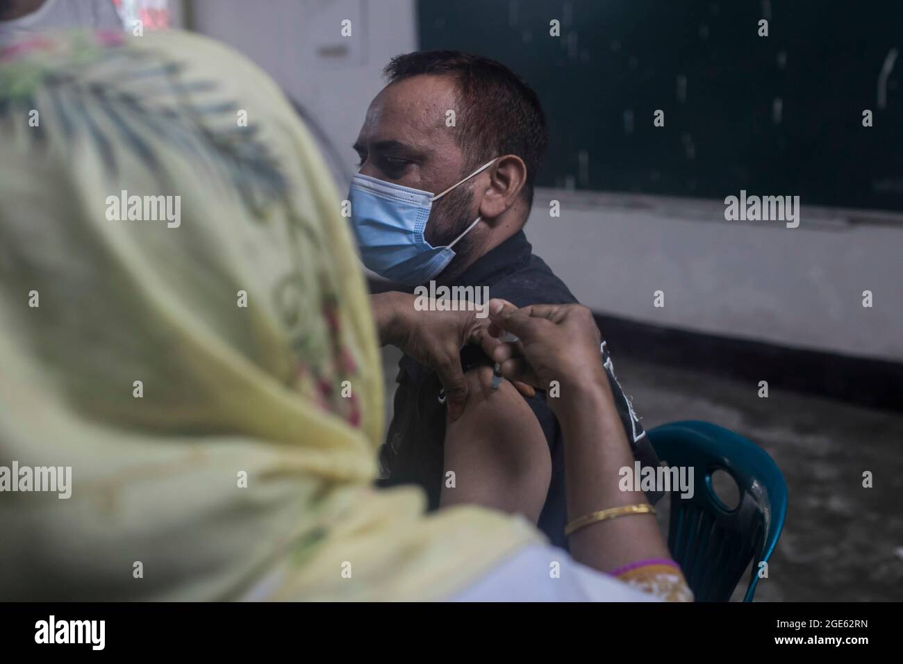 DHAKA, BANGLADESCH - 8. AUGUST: Eine Gesundheitsarbeiterin verabreicht einer Person während einer Massenimpfkampagne in einem Impfzentrum eine Dosis des Impfstoffs Moderna COVID19. Nach Angaben der Generaldirektion für Gesundheitsdienste in Bangladesch (DGHS) startet das landesweite Massenimpfungsprogramm seine Impfkampagne mit dem Ziel, innerhalb von sechs Tagen 3.5 Millionen Menschen zu impfen. Bangladesch hat seit Beginn der Pandemie fast 1.31 Millionen Coronavirus-Infektionen und 21,638 Todesfälle verzeichnet. Am 8. August 2021 in Dhaka, Bangladesch. Quelle: Eyepix Group/The Photo Access Stockfoto