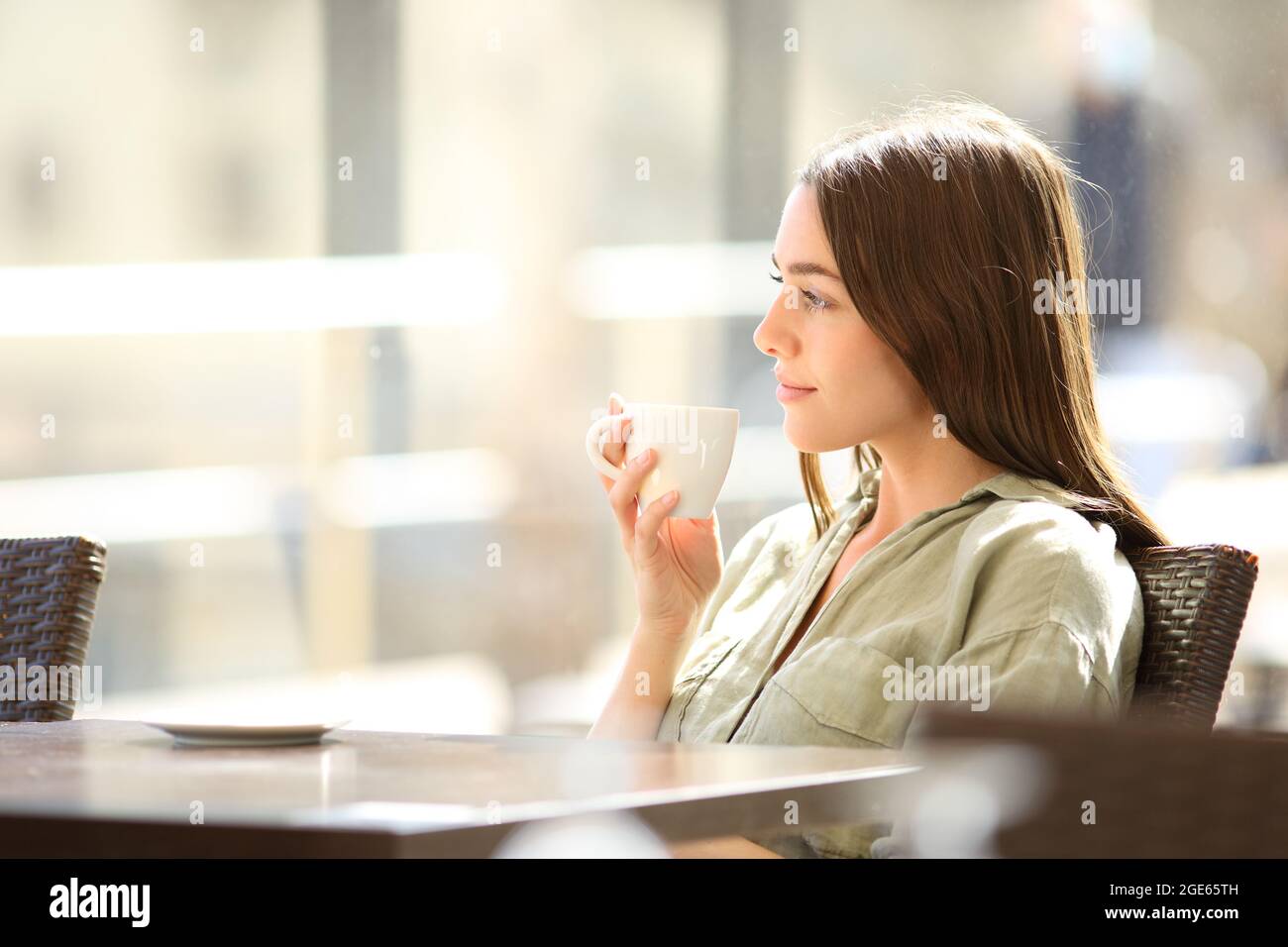 Seitenansicht Porträt einer entspannten Frau, die sich Gedanken über das Kaffeetrinken in einer Bar machen kann Stockfoto