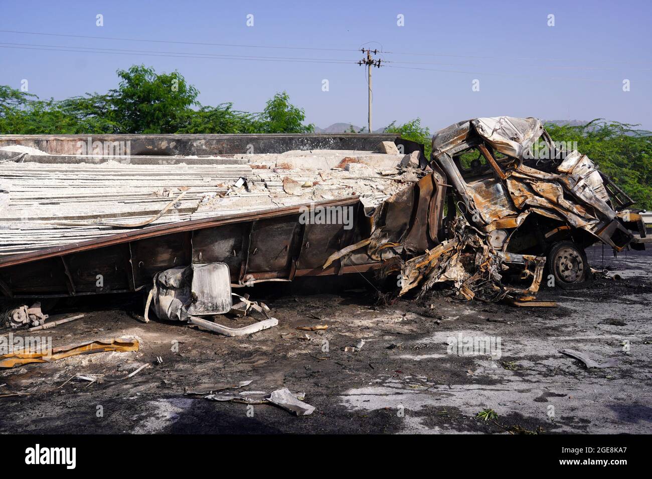 Nicht exklusiv: Ein Arbeiter wird gesehen, wie er den LKW überprüft, der nach dem Unfall beschädigt wurde. Ein Feuer bricht aus nach einer Kollision zwischen zwei LKWs auf einem Nat Stockfoto