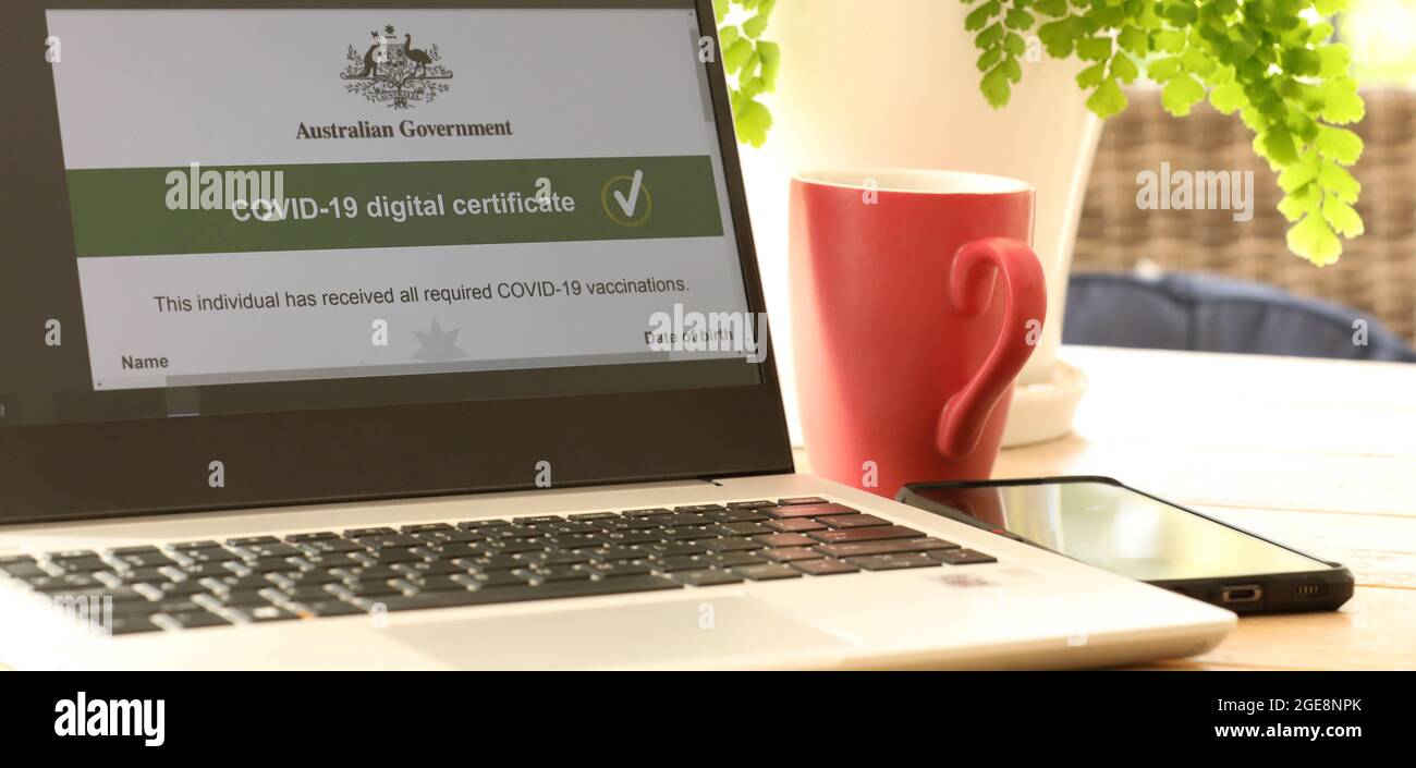 Ein Computer-Laptop mit dem digitalen Covid-19-Impfpass der australischen Regierung wird auf dem Bildschirm geöffnet. Grünes Häkchen bedeutet, dass beide Dosen abgeschlossen sind. Stockfoto