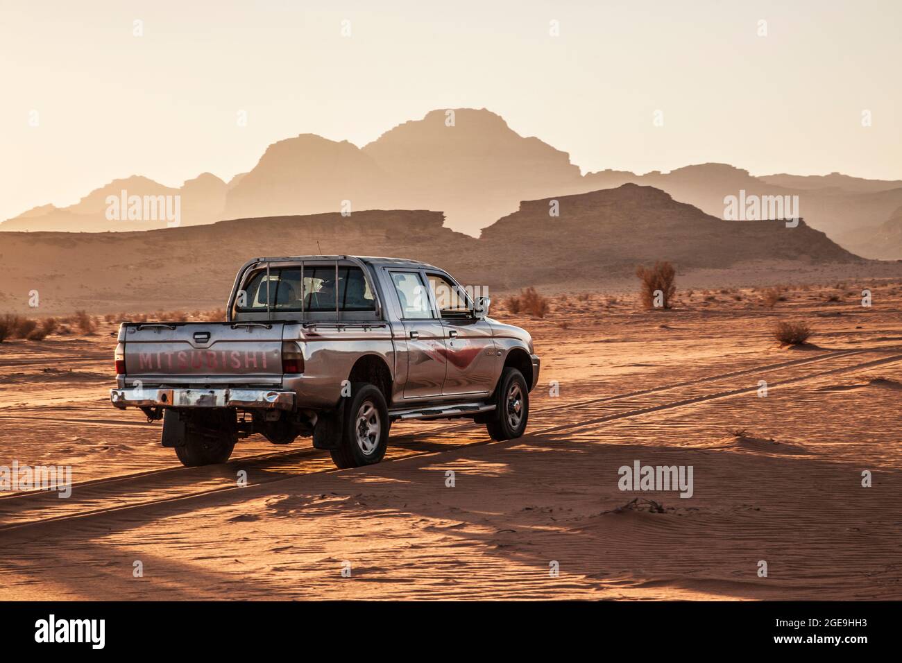 Ein Mitsubishi touristische Jeep bei Sonnenuntergang in der jordanischen Wüste im Wadi Rum oder das Tal des Mondes. Stockfoto