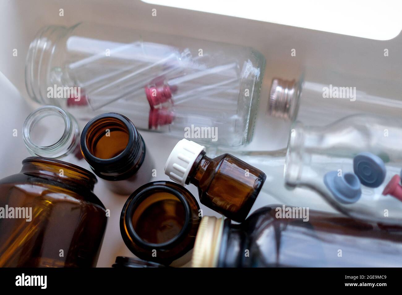 Glasflaschen unterschiedlicher Größe in einer Schachtel. Dunkles Glas Stockfoto