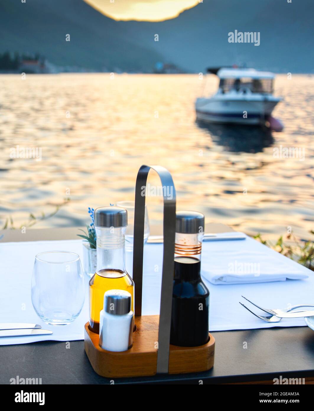 Im Spätsommer ein wunderschönes romantisches Touristenziel am Rande der Kotor Bay mit Besteck, Gewürzen und Servietten, die frisch für den Abend arrangiert wurden Stockfoto