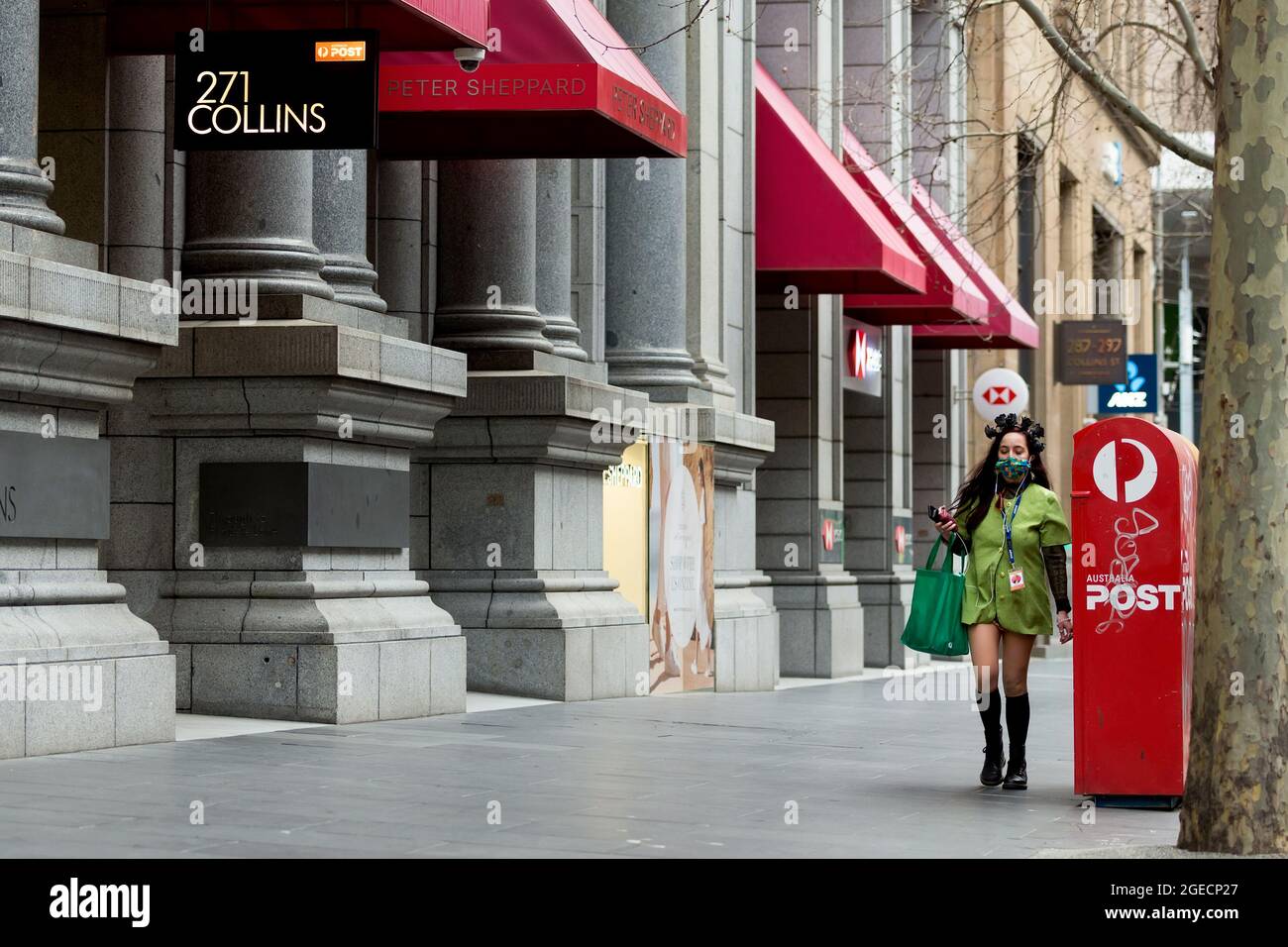 Melbourne, Australien, 3. August 2020. Eine Frau, die ein kunstvolles Haarteil und eine Gesichtsmask trägt, wird während der COVID-19 in Melbourne, Australien, an der 271 Collins Street spazieren sehen. Während Melbourne seinen ersten Tag der Beschränkungen der Stufe 4 erlebt, sowie eine Ausgangssperre von 20:00 bis 5:00 Uhr, kündigte Premier Daniel Andrews heute den Plan für die Stilllegung für alle außer den wichtigsten Unternehmen für mindestens die nächsten 6 Wochen an. Victoria verzeichnete weitere 429 COVID-19-Fälle und 13 weitere Todesfälle, was die Gesamtzahl der aktiven Fälle in den Bundesstaaten auf 6,489 brachte. Kredit: Dave Hewison/Speed Media/Alamy Live Nachrichten Stockfoto