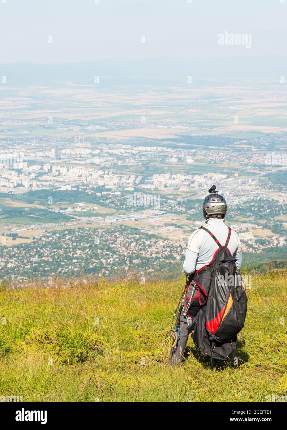 Gleitschirmflieger mit Gurtzeug bereitet sich auf den Start am Vitosha-Berg mit Blick auf Sofia, Bulgarien vor Stockfoto