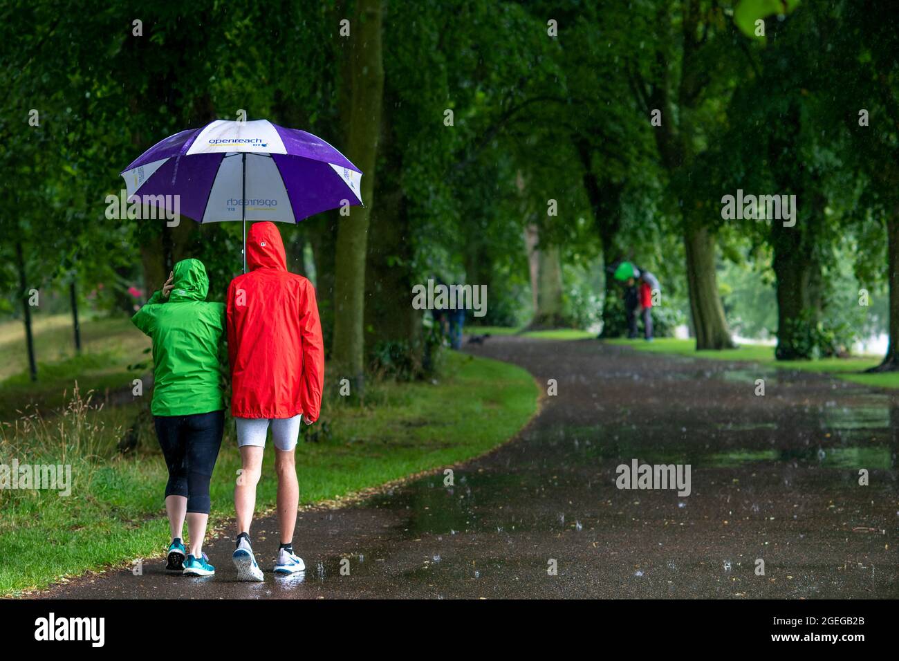 Zwei 5K-Rennbesucher, die zu ihrem Beobachtungspunkt im Bitts Park, Carlisle, August 2021, laufen Stockfoto