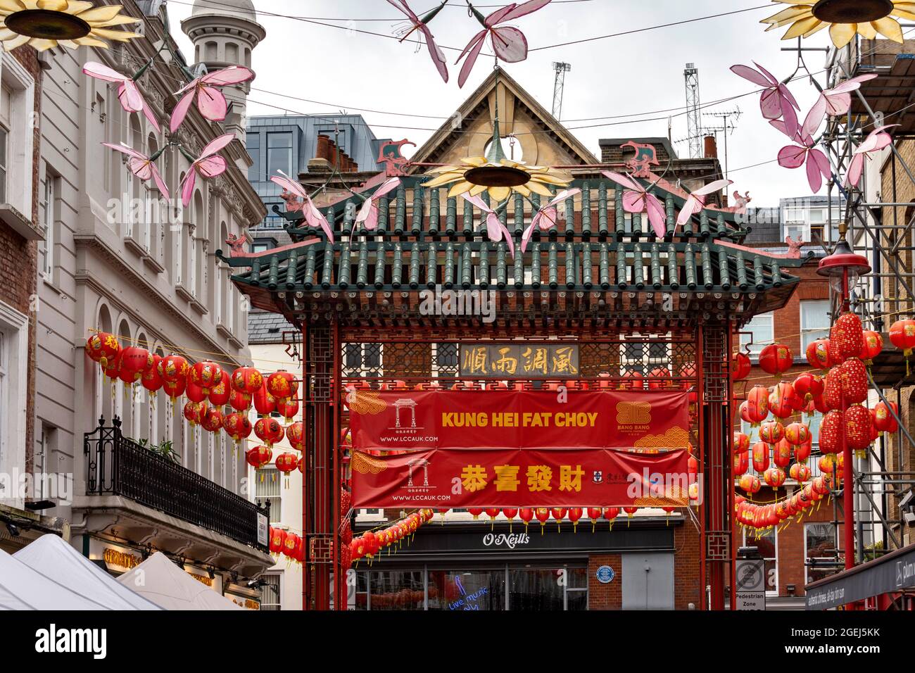 LONDON CHINATOWN GERRARD STREET GATEWAY UND BANNER ÜBERSETZT ALS „Wir wünschen Ihnen viel Glück und Wohlstand“ Stockfoto