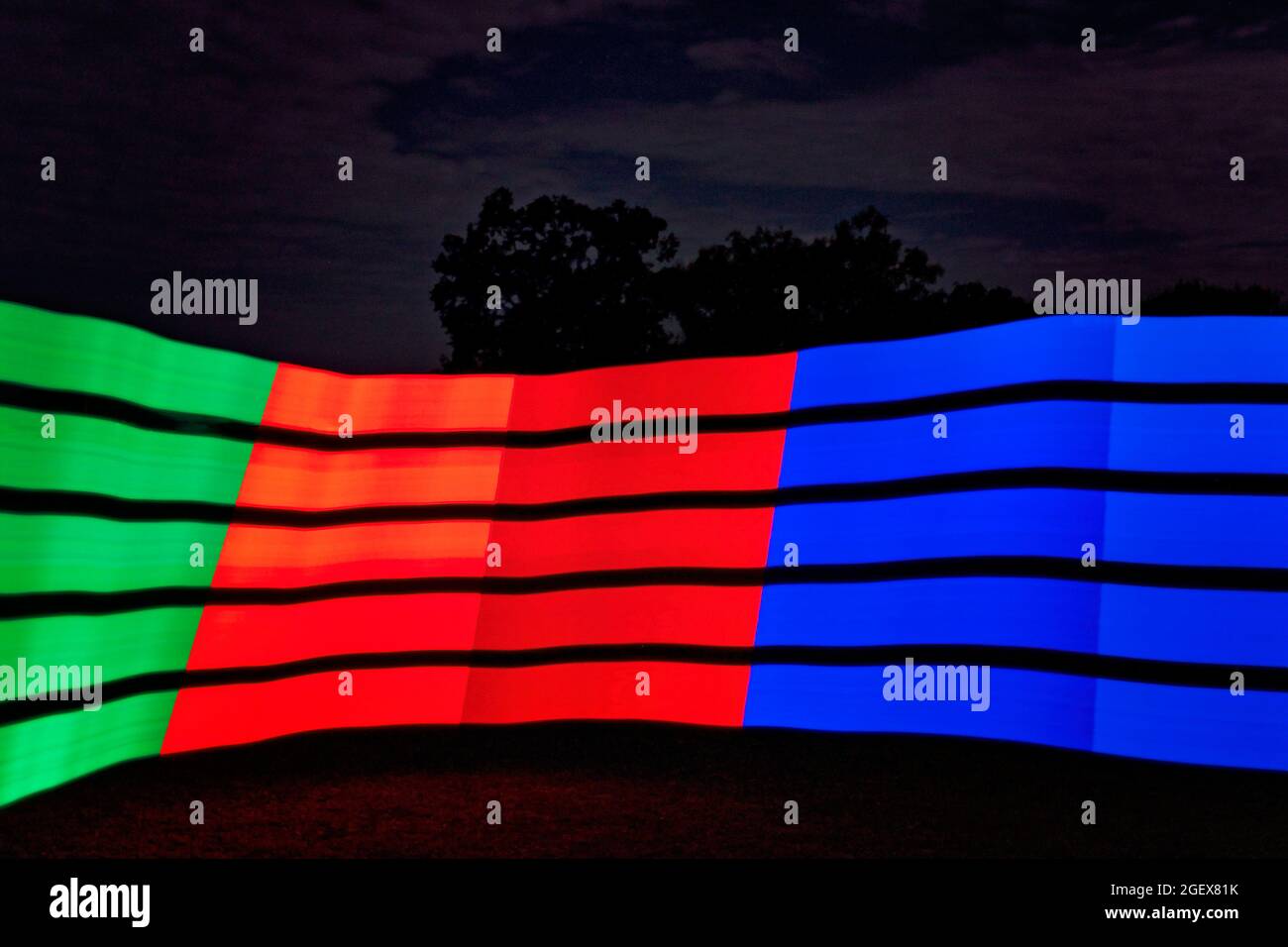 Streifen von farbigem Licht vor einem dunklen Nachthintergrund gemalt Stockfoto
