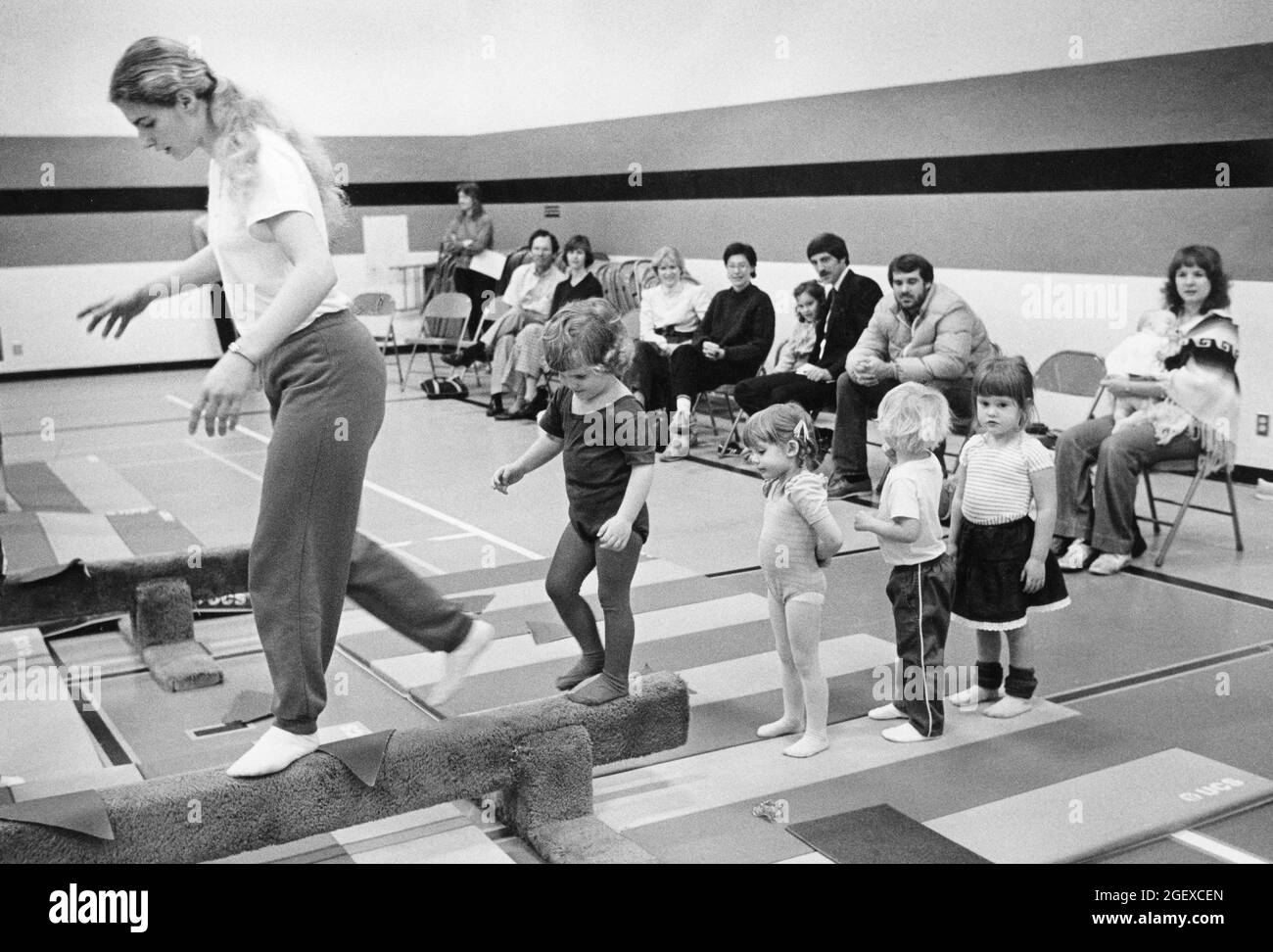 Austin Texas USA, um 1989: Mütter und Väter beobachten ihre Kleinkinder während des Elterntages im Gemeinschaftsschulgymnastik am Gleichgewichtsstrahl. ©Bob Daemmrich Stockfoto