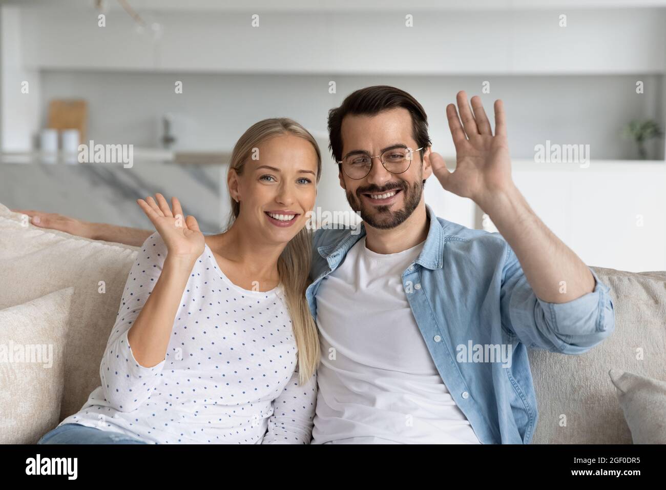 Glückliches Millennials-Paar winkt hallo und lächelt an der Webcam Stockfoto