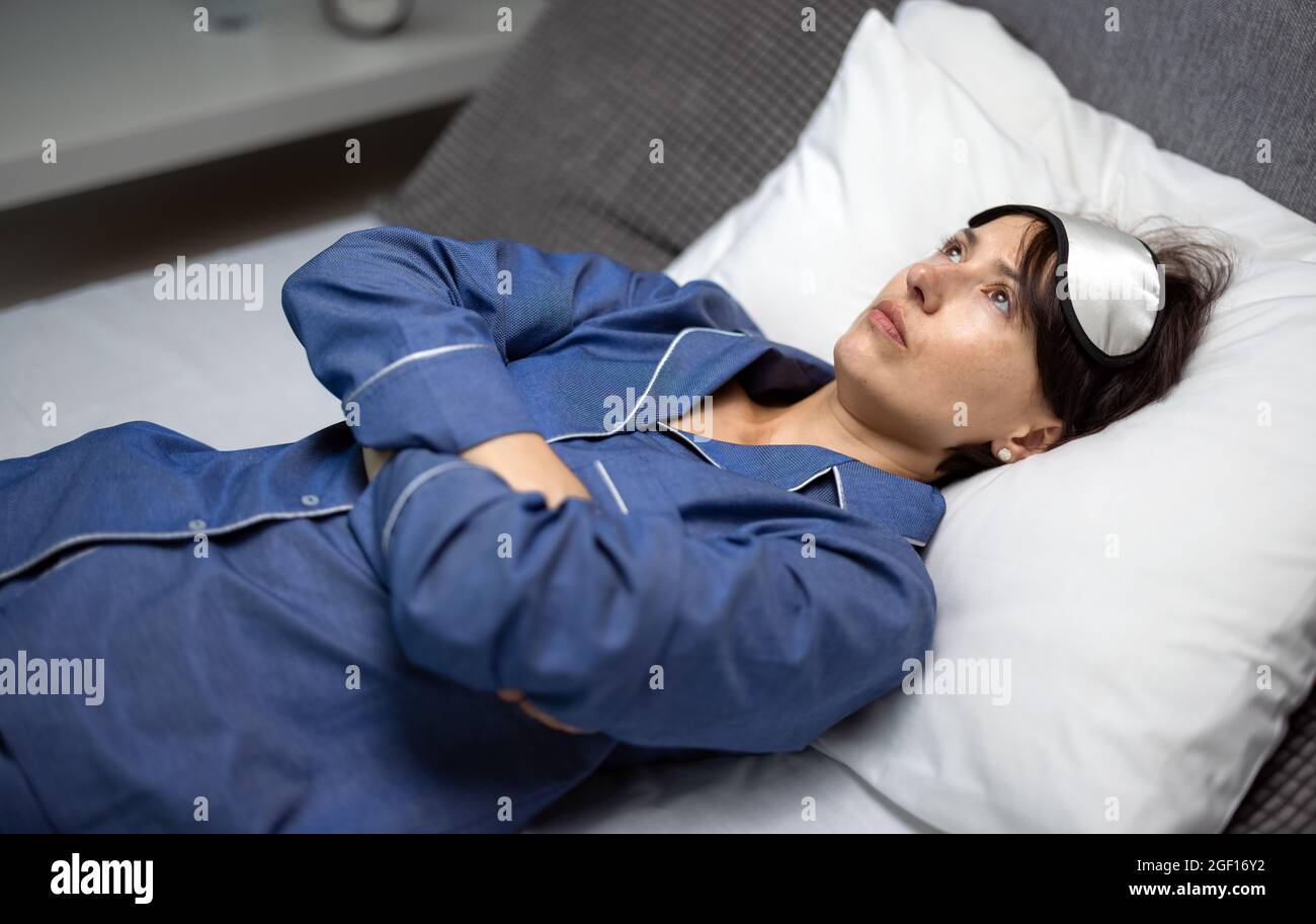 Schlaflose Frau im Bett Stockfoto