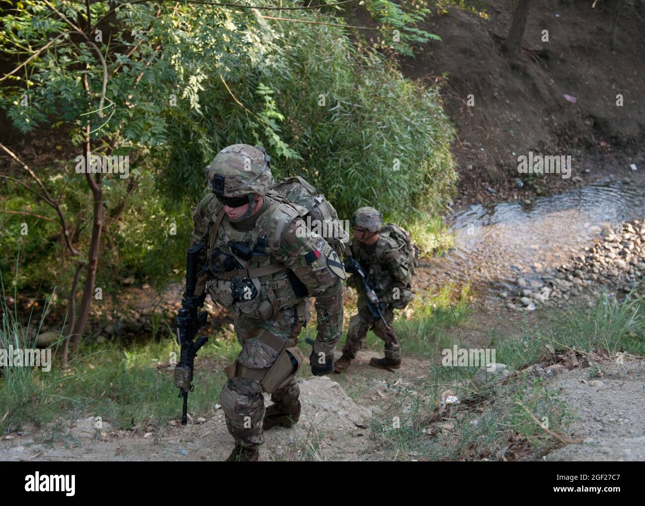 US-Soldaten, die der Bravo-Truppe, der 4. Staffel, dem 9. Kavallerieregiment, der 2. Panzerbrigade-Kampfmannschaft, der 1. Kavallerie-Division zugewiesen wurden, erkämpfen sich während einer Anwesenheitspatrouille um die Vorwärtsoperationsbasis Fenty in der Provinz Nangarhar, Afghanistan, am 22. August 2013 die Seite einer Schlucht Der Zweck der morgendlichen Patrouille war es, die Sicherheit von Fentys Umkreis zu überprüfen und die lokale Bevölkerung zu engagieren. (USA Foto der Armee-Nationalgarde von Sgt. Margaret Taylor/Freigegeben) Stockfoto