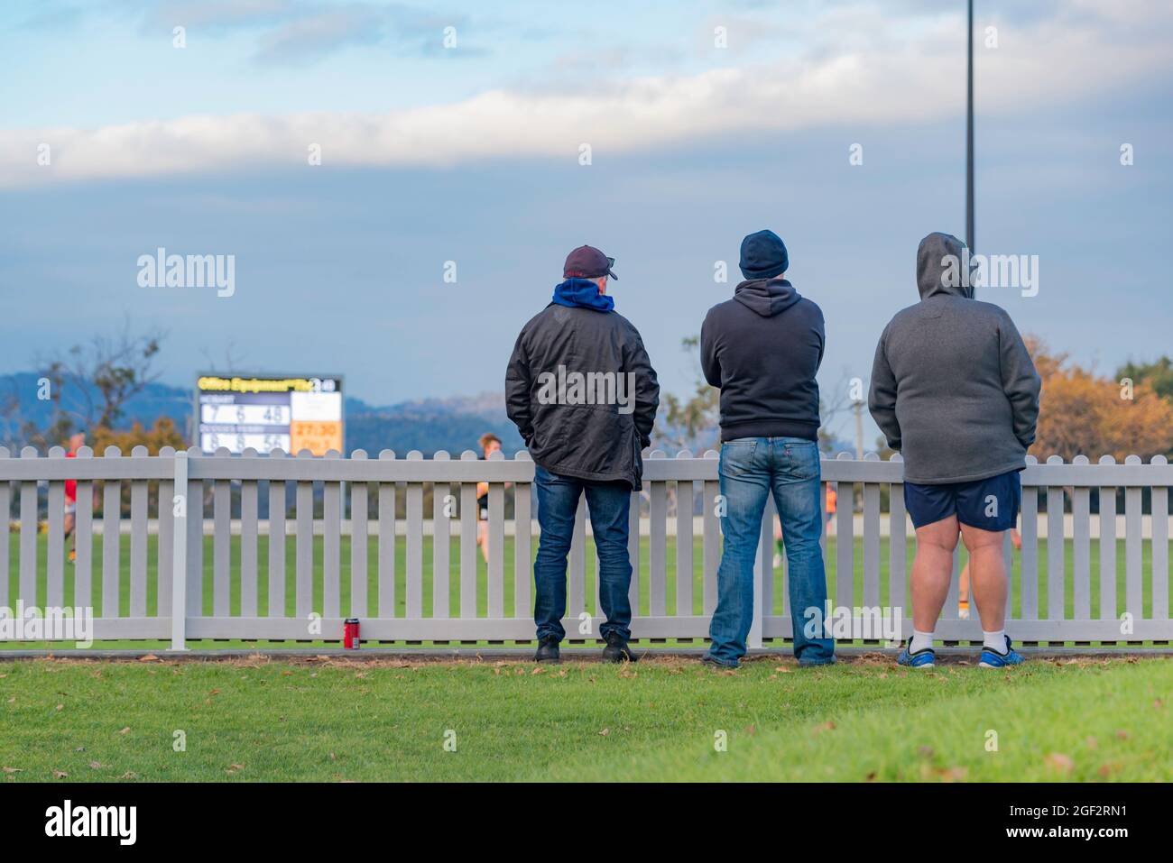Eine sehr kleine Gruppe (3) Fans beobachten ein Spiel des australischen Fußballs (AFL) zwischen Hobart und Dodges Ferry Club auf dem TCA Ground in Hobart, Tasmanien Stockfoto