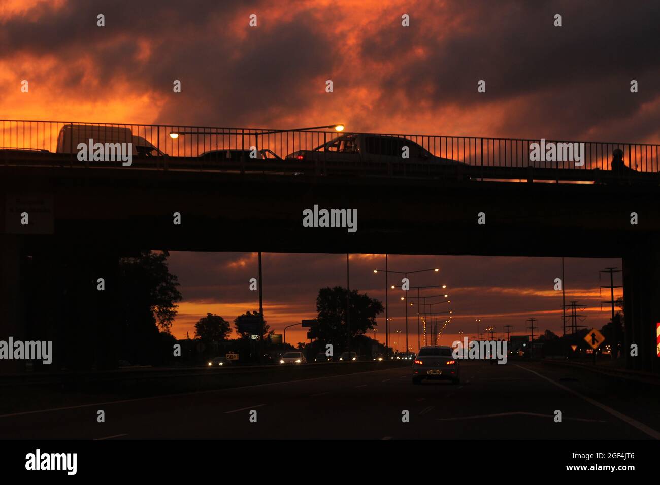 Abendliche Stadtansicht einer Autobahn und einer Brücke mit Autos Stockfoto