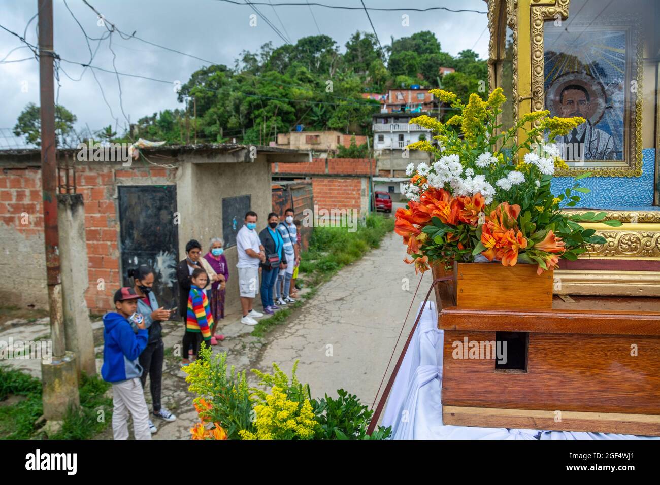 Gemeindemitglieder beobachten das Auto, das die Reliquie von Jose Gregorio Hernandez trägt, während es eine Tour durch verschiedene Gegenden von Caracas macht. Relikt des seligen José Stockfoto