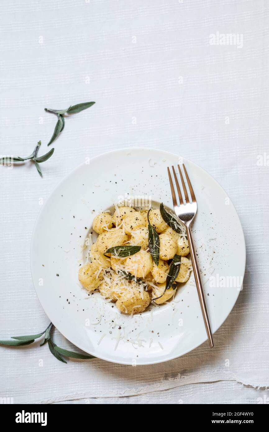 Teller mit verzehrfertigen italienischen Gnocchi-Knödeln mit geriebenem Parmesan-Käse Stockfoto