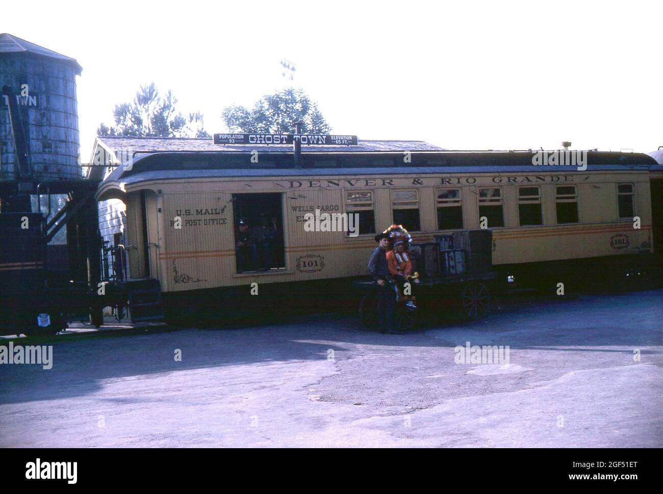 Knott's Berry Farm, Orange County, Kalifornien. 1959. Einheimische amerikanische und Cowboy-Schauspieler entspannen sich auf einem Wagen vor der No.101, einem ehemaligen Eisenbahnwaggon der Denver & Rio Grande Railroad, der auf der Ghost Town & Calico Railroad am Ghost Town Station fährt. Stockfoto