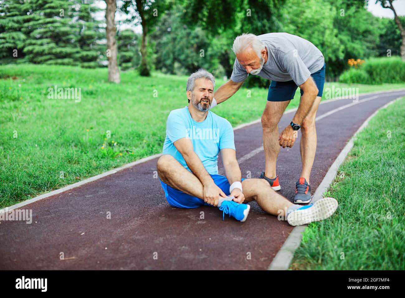 Outdoor Senior Fitness Mann Lifestyle aktiv Sport Übung Verletzung Schmerzen Schmerzen Bein Knieangel helfen, Freund zu unterstützen Stockfoto