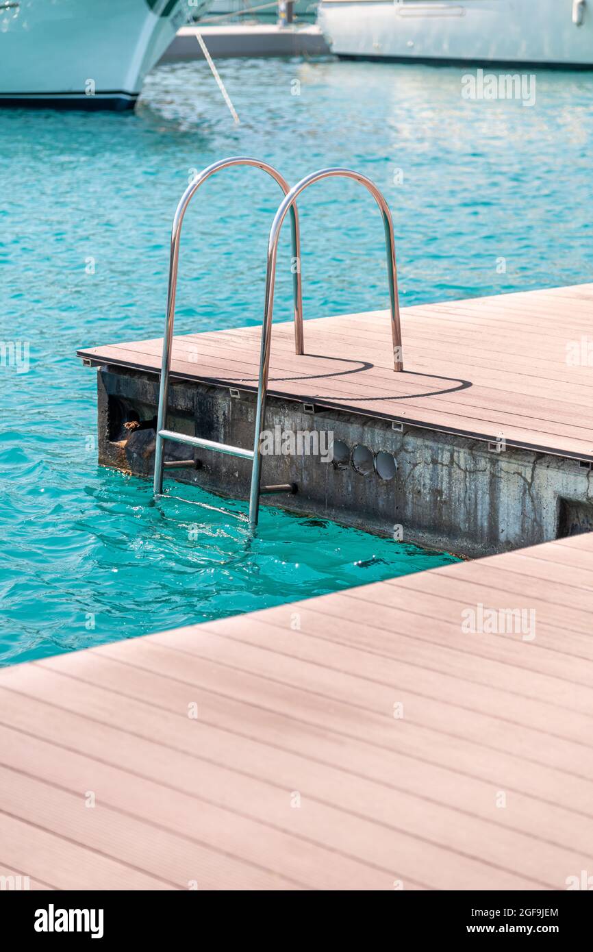 Schwimmende Anlegestelle mit Verbunddeck und Leiter an der Marina. Stockfoto