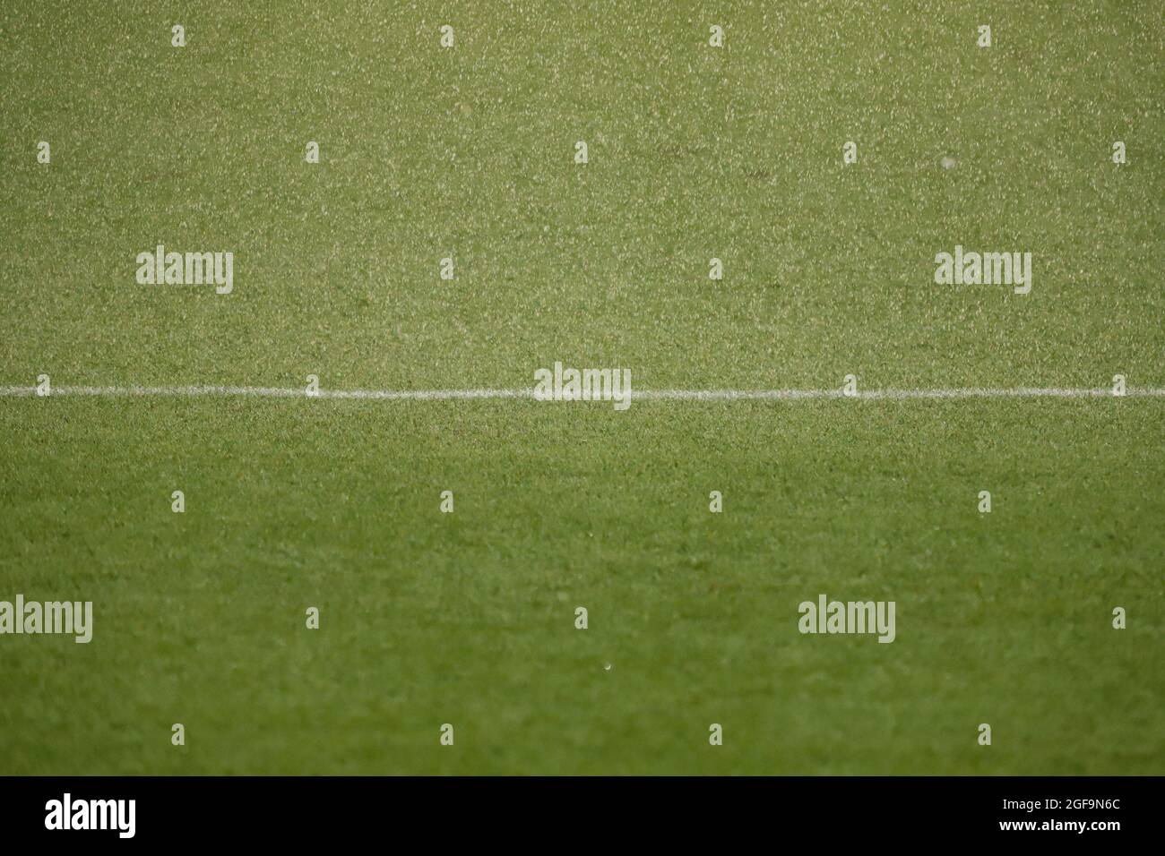 Fußballfeld mit Kunstrasen, die auf der Oberseite benetzt, mit einer weißen Linie Stockfoto