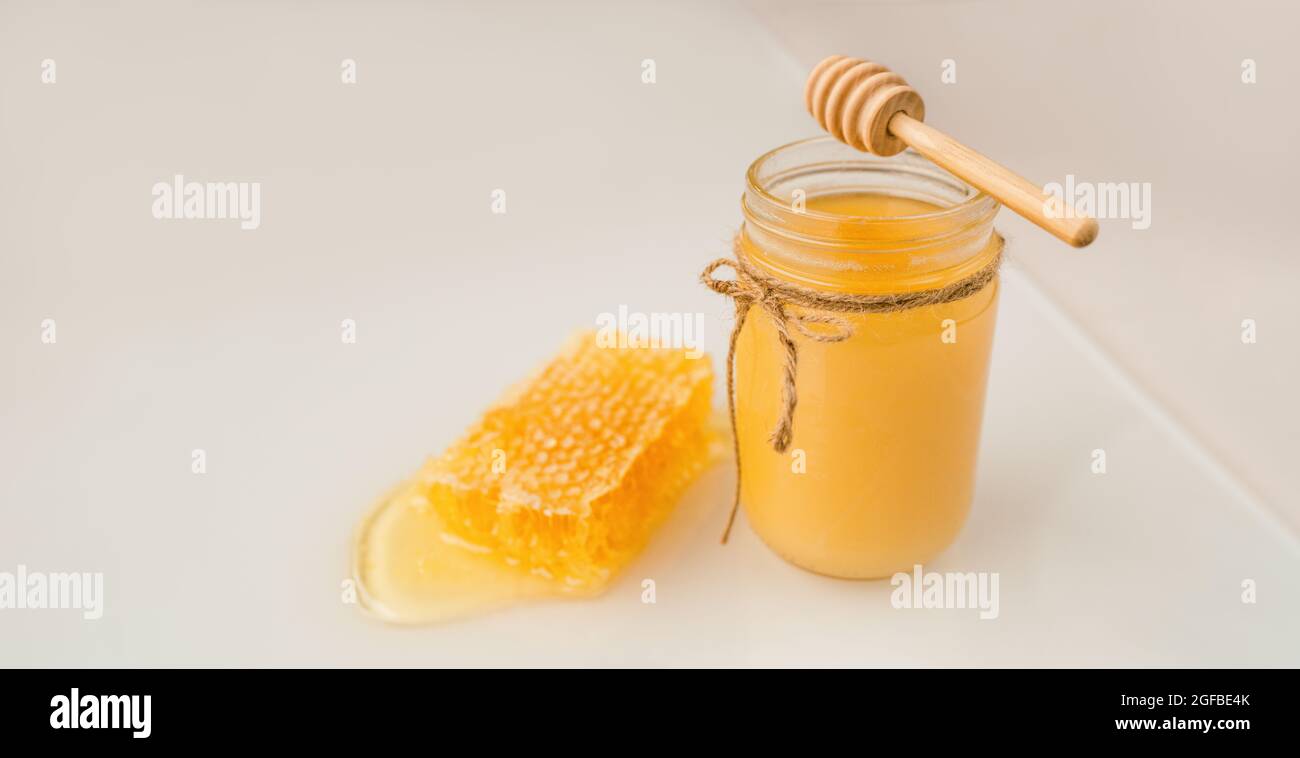 Honig Dipper und Glas creamed Amber Bio-Honigbiene Ernte neben frischen Wabenfutter Banner Panorama Stockfoto