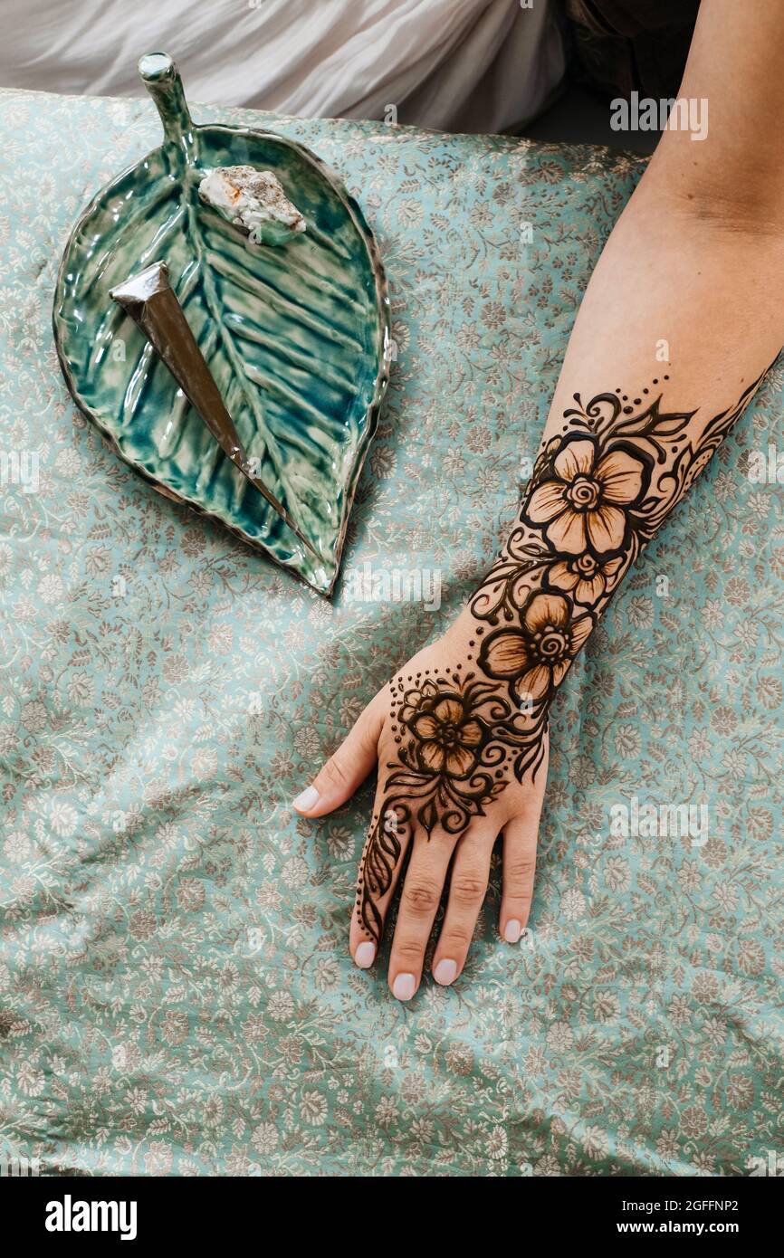 Draufsicht Kunst Henna Tattoo auf Frauen Hände. Master Künstler Zeichnung Arabisch Mehndi für Braut vor der Hochzeit. Nahaufnahme, Ansicht von oben. Florales Dessin. Kegel Stockfoto