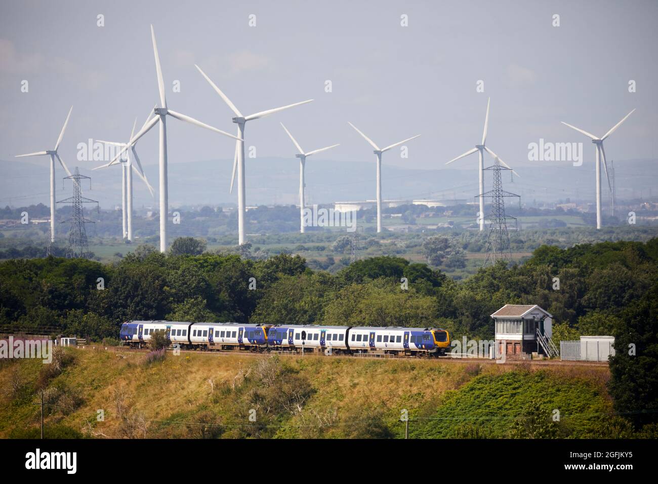 Der Zug überquert den Weaver Viadukt in Frodsham, cheshire. Und Frodsham Wind Farm große Onshore-Kraftwerke Stockfoto