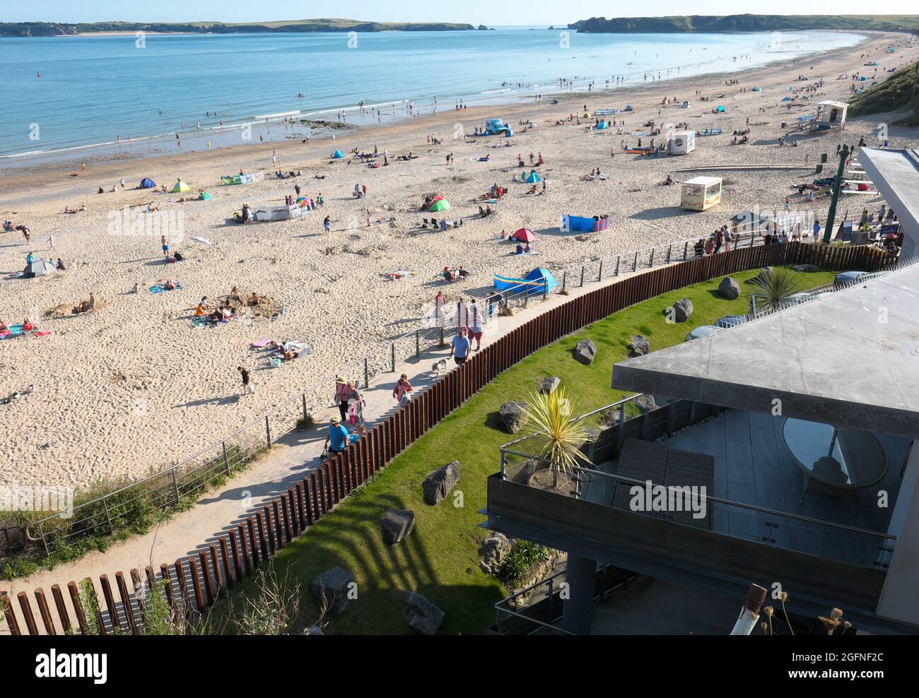 Tenby Wales - der South Beach, der im August 2021 am Abend gesehen wurde, war voll mit Besuchern Stockfoto
