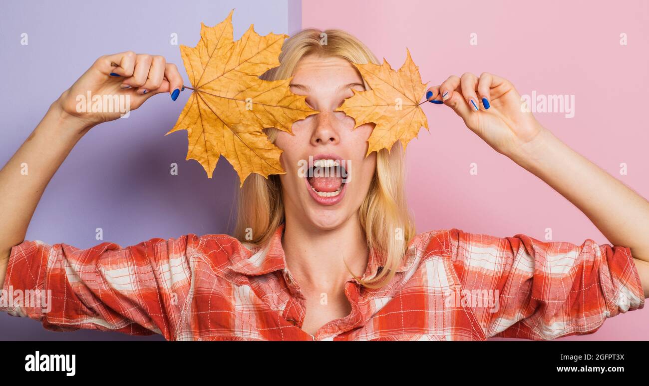 Modetrend Herbst. Überrascht Mädchen mit Ahornblättern. Schöne Frau mit goldenem Blatt. Herbstliche Stimmung. Stockfoto