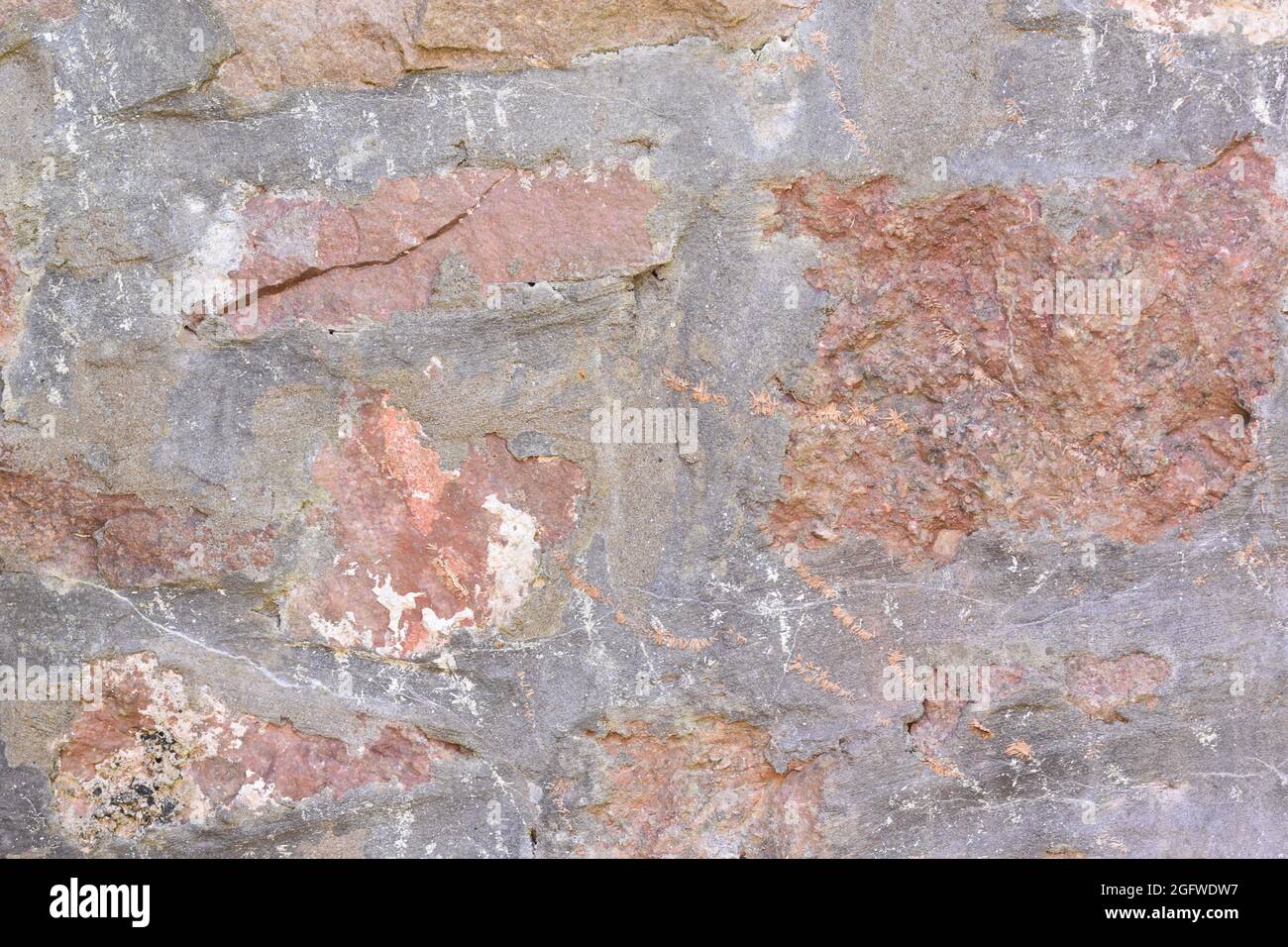 Eine alte Steinmauer für einfache Hintergründe und Kulissen Stockfoto