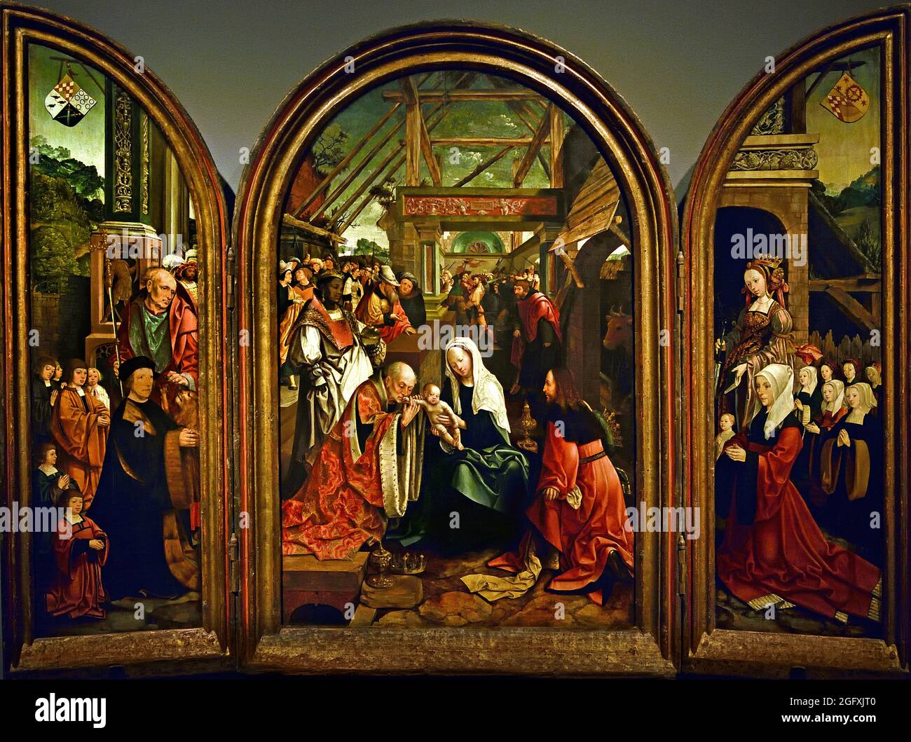 Die Anbetung der drei Könige, 1517 von Jacob Cornelisz. Van Oostsanen, 1472-1533 ( Könige das Kind Jesus. Auf den Seitenwänden sind die Schutzpatrone, die Kinder und die Schutzheiligen dargestellt. Vater mit sechs Söhnen und der heilige Hieronymus, Mutter mit sieben Töchtern und die heilige Katharina. Zwei Kinder, in weißen Gewand dargestellt, waren bereits gestorben.) Stockfoto