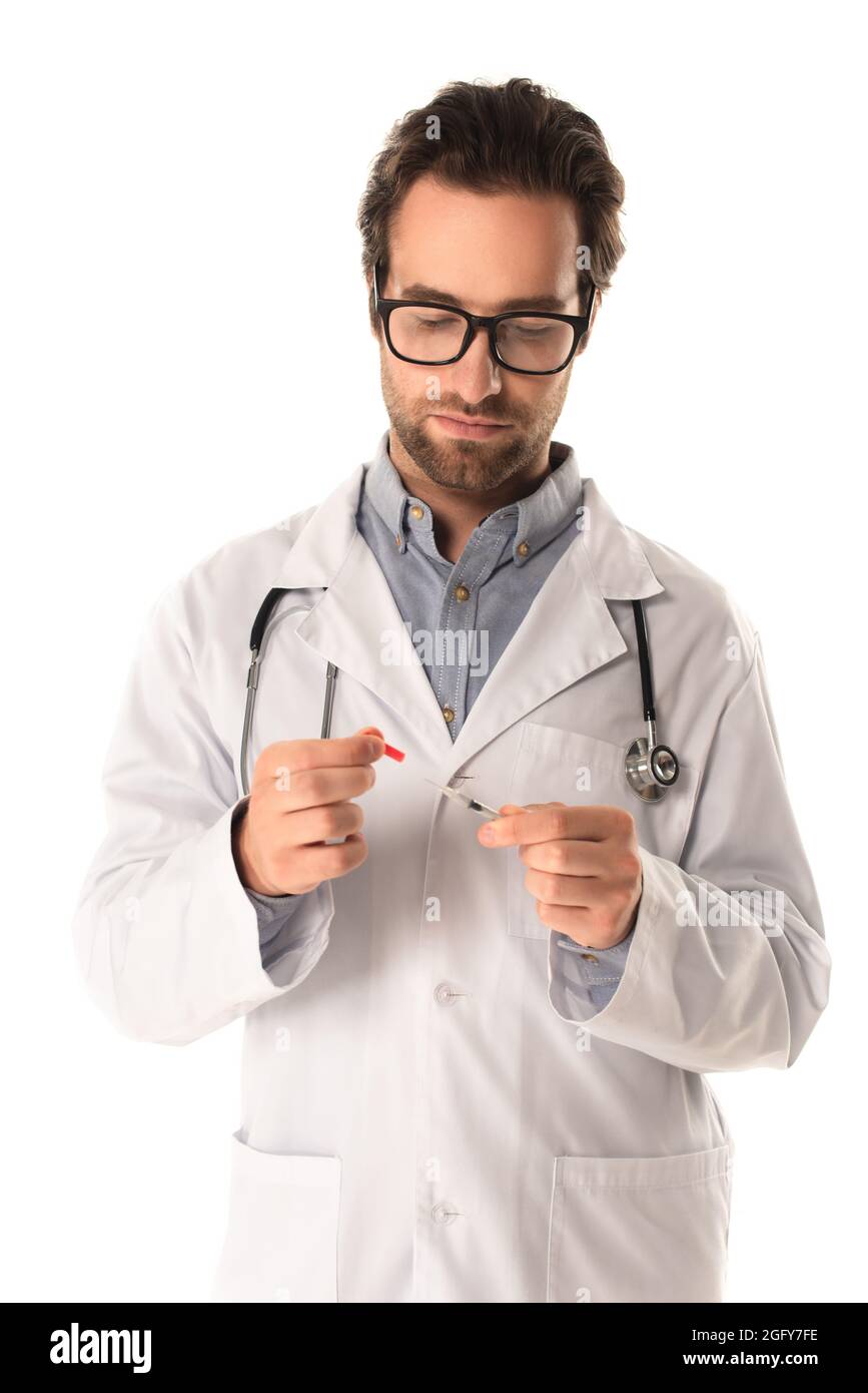 Arzt in einer Brille, die Spritze und Kappe isoliert auf Weiß hält  Stockfotografie - Alamy