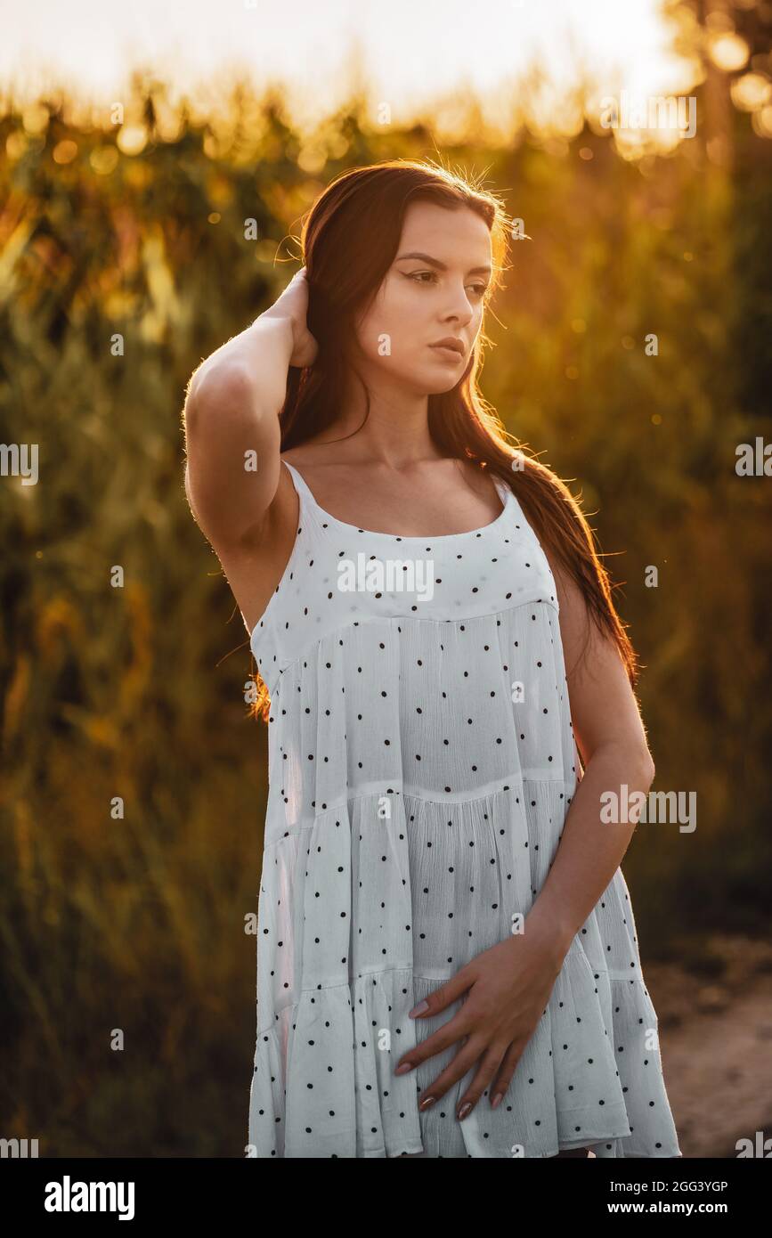 Junge schöne Frau in weißem Kleid im Maisfeld. Stockfoto