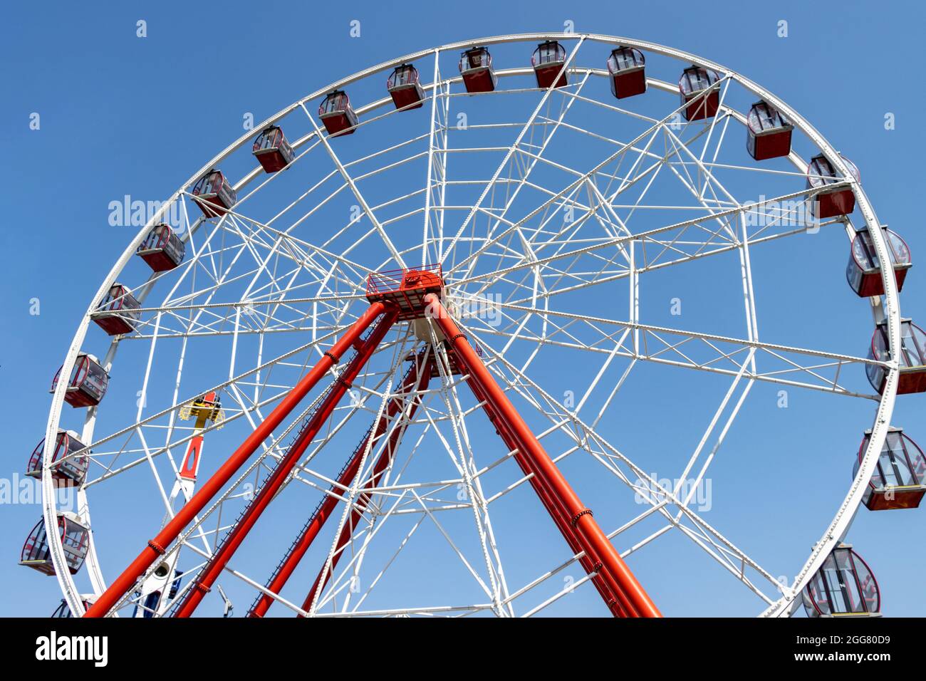 Das Riesenrad dreht sich an einem sonnigen Tag im Vergnügungspark. Keine Personen Stockfoto