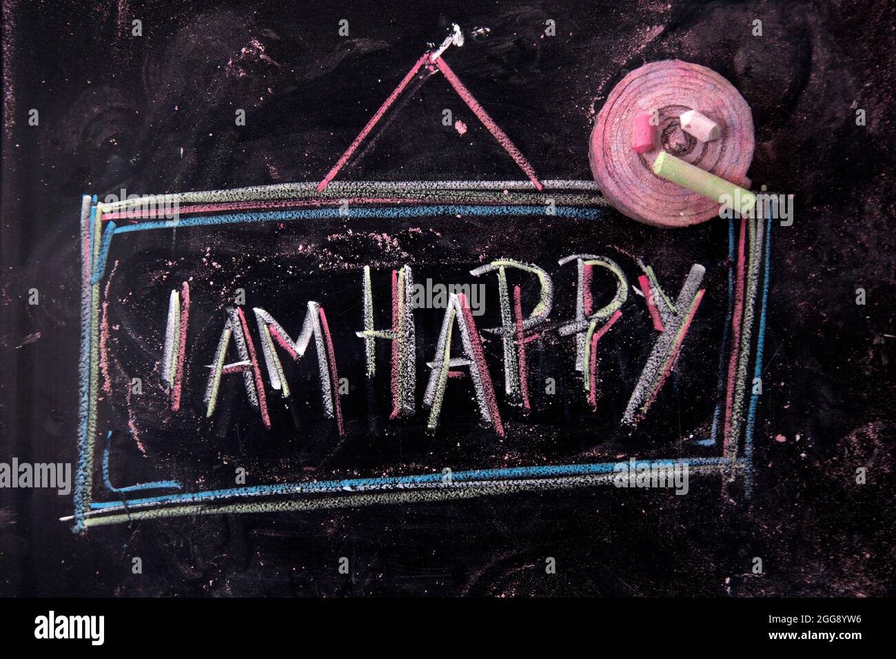 Grafische Darstellung des Wortes, glücklich, geschrieben mit Kreide auf Tafel Stockfoto